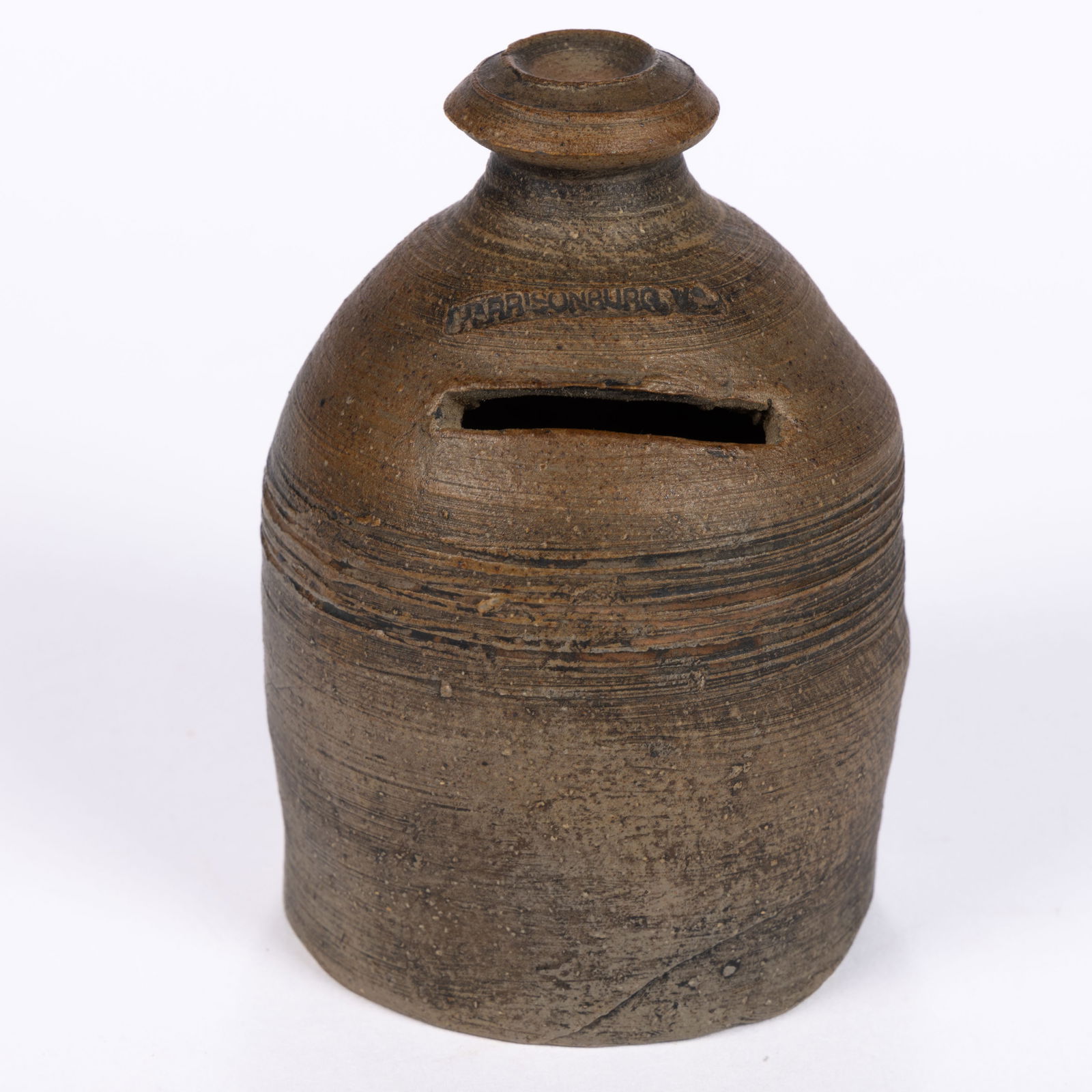 STAMPED "HARRISONBURG, VA" SHENANDOAH VALLEY OF VIRGINIA STONEWARE MONEY BANK: STAMPED "HARRISONBURG, VA" SHENANDOAH VALLEY OF VIRGINIA STONEWARE MONEY BANK, salt-glazed, beehive form with turned finial, stamped above coin slot. Fourth quarter 19th/early 20th century.