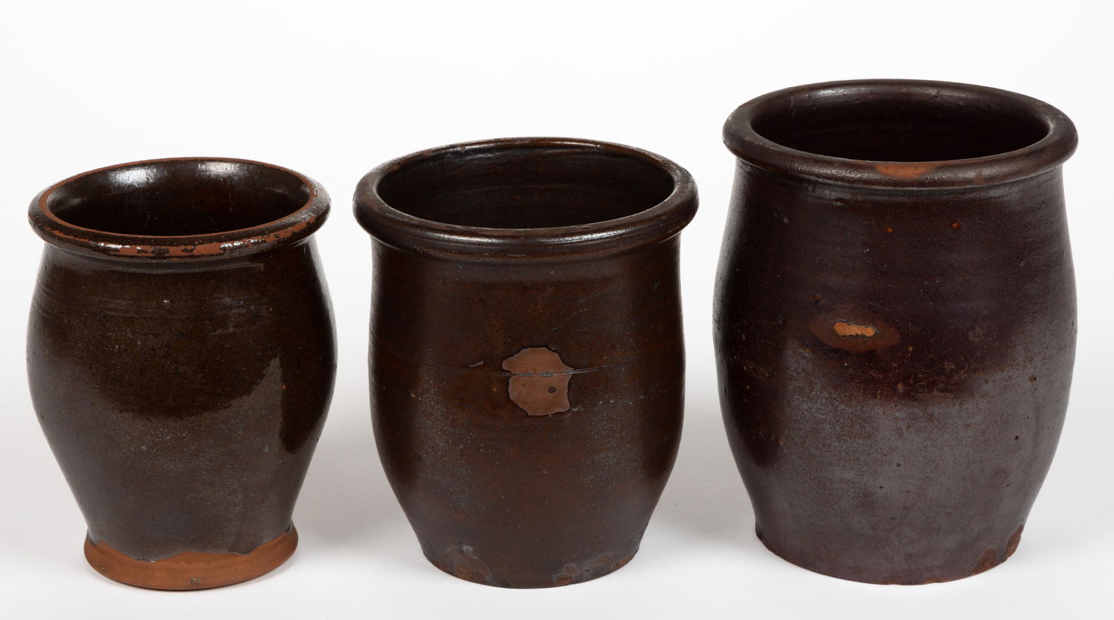 MID-ATLANTIC EARTHENWARE / REDWARE JARS, LOT OF THREE: MID-ATLANTIC EARTHENWARE / REDWARE JARS, LOT OF THREE, lead-glazed, each of ovoid form with rounded rims, comprising two approximately one-quart capacity examples including one with pronounc
