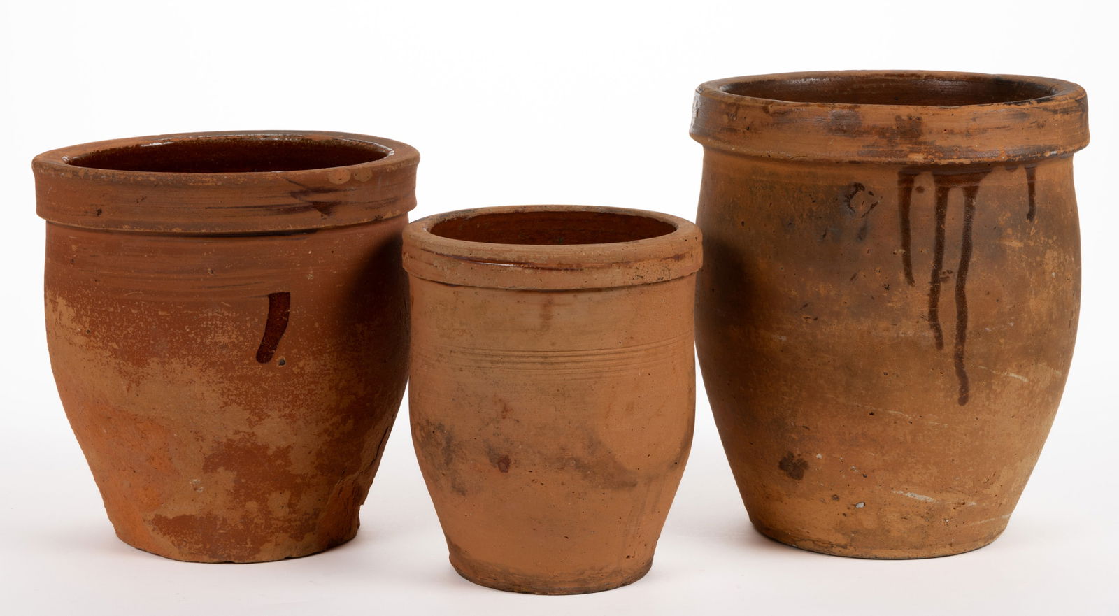 MID-ATLANTIC EARTHENWARE / REDWARE CROCKS, LOT OF THREE: MID-ATLANTIC EARTHENWARE / REDWARE CROCKS, LOT OF THREE, each single lead-glazed with collared rims, comprising two approximately one-gallon capacity examples and one approximately half-gallon ca