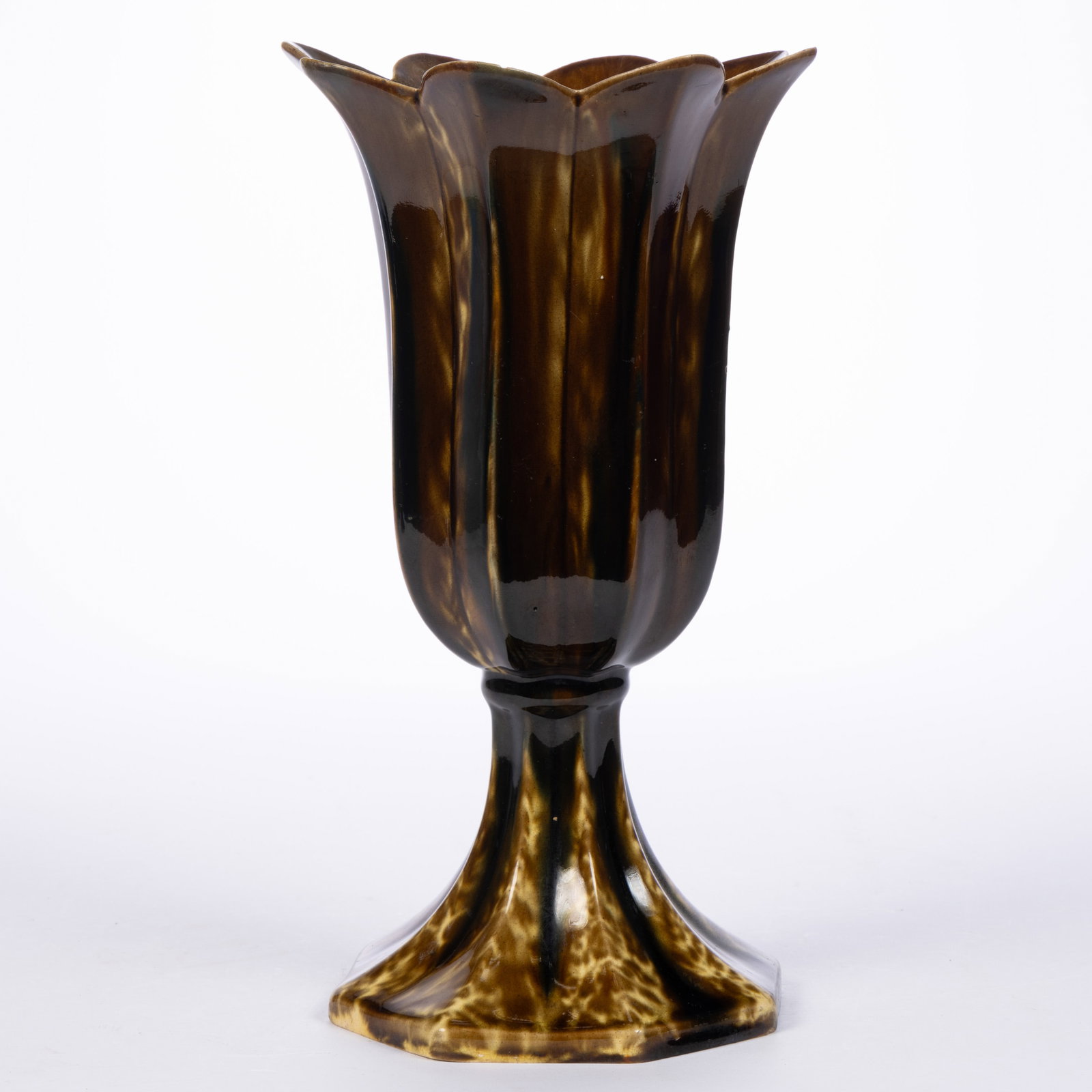 AMERICAN BENNINGTON ATTRIBUTED FLINT ENAMEL ROCKINGHAM-GLAZED POTTERY TULIP VASE: AMERICAN BENNINGTON ATTRIBUTED FLINT ENAMEL ROCKINGHAM-GLAZED POTTERY TULIP VASE, mottled brown and dark blue glazes, having deep bowl form with an eight-petaled rim, raised on an octagonal base.