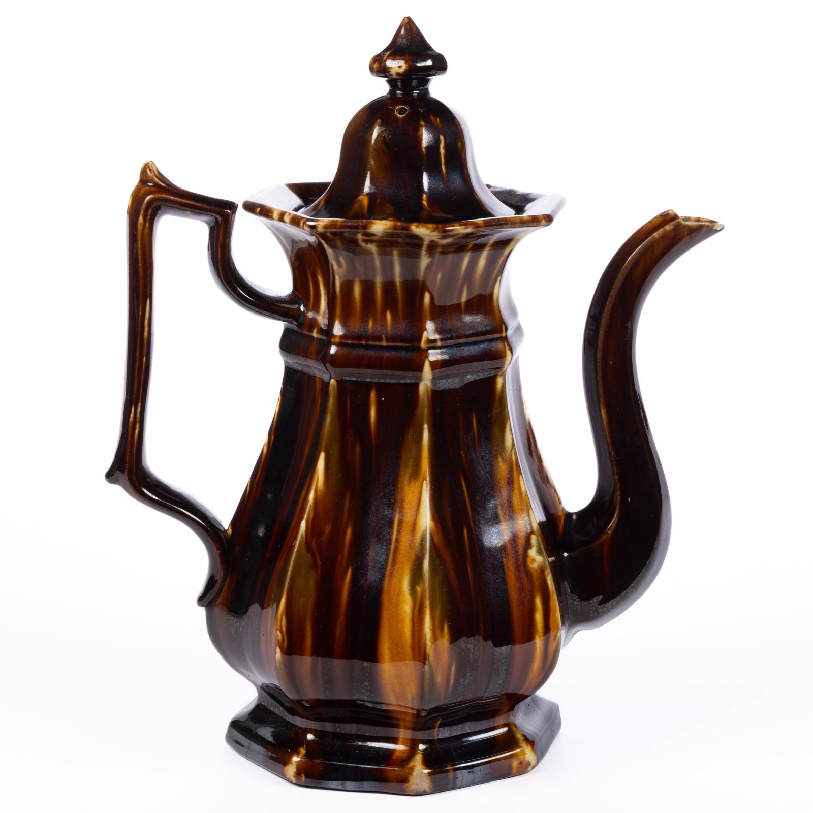 AMERICAN STAMPED BENNINGTON FLINT ENAMEL ROCKINGHAM-GLAZED POTTERY COFFEE POT: AMERICAN STAMPED BENNINGTON FLINT ENAMEL ROCKINGHAM-GLAZED POTTERY COFFEE POT, mottled brown, olive green, and orange glazes, baluster form with an octagonal base, panelled body, and helmet cover