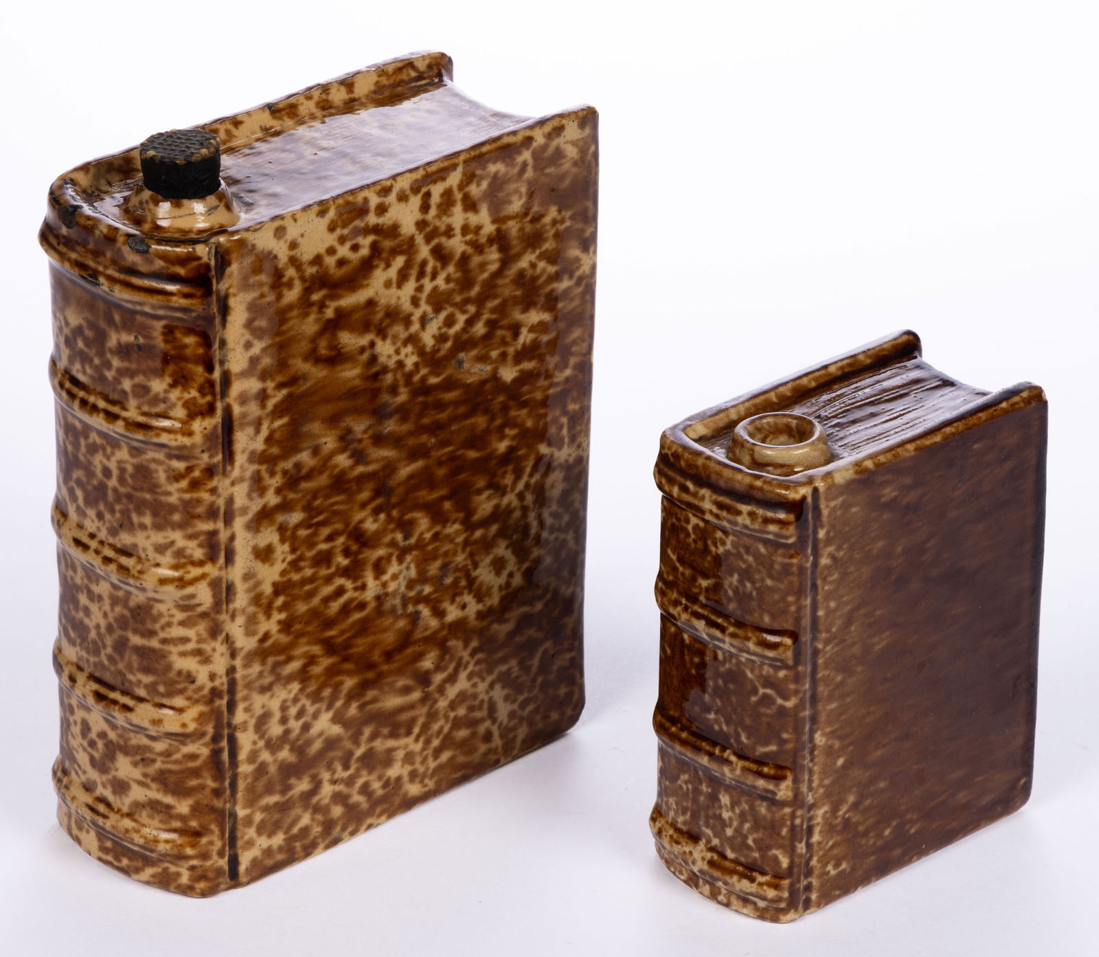 AMERICAN BENNINGTON ATTRIBUTED ROCKINGHAM-GLAZE POTTERY BOOK FLASKS, LOT OF TWO: AMERICAN BENNINGTON ATTRIBUTED ROCKINGHAM-GLAZE POTTERY BOOK FLASKS, LOT OF TWO, each mottled brown, untitled, comprising an approximately one-pint capacity example and an approximately two-