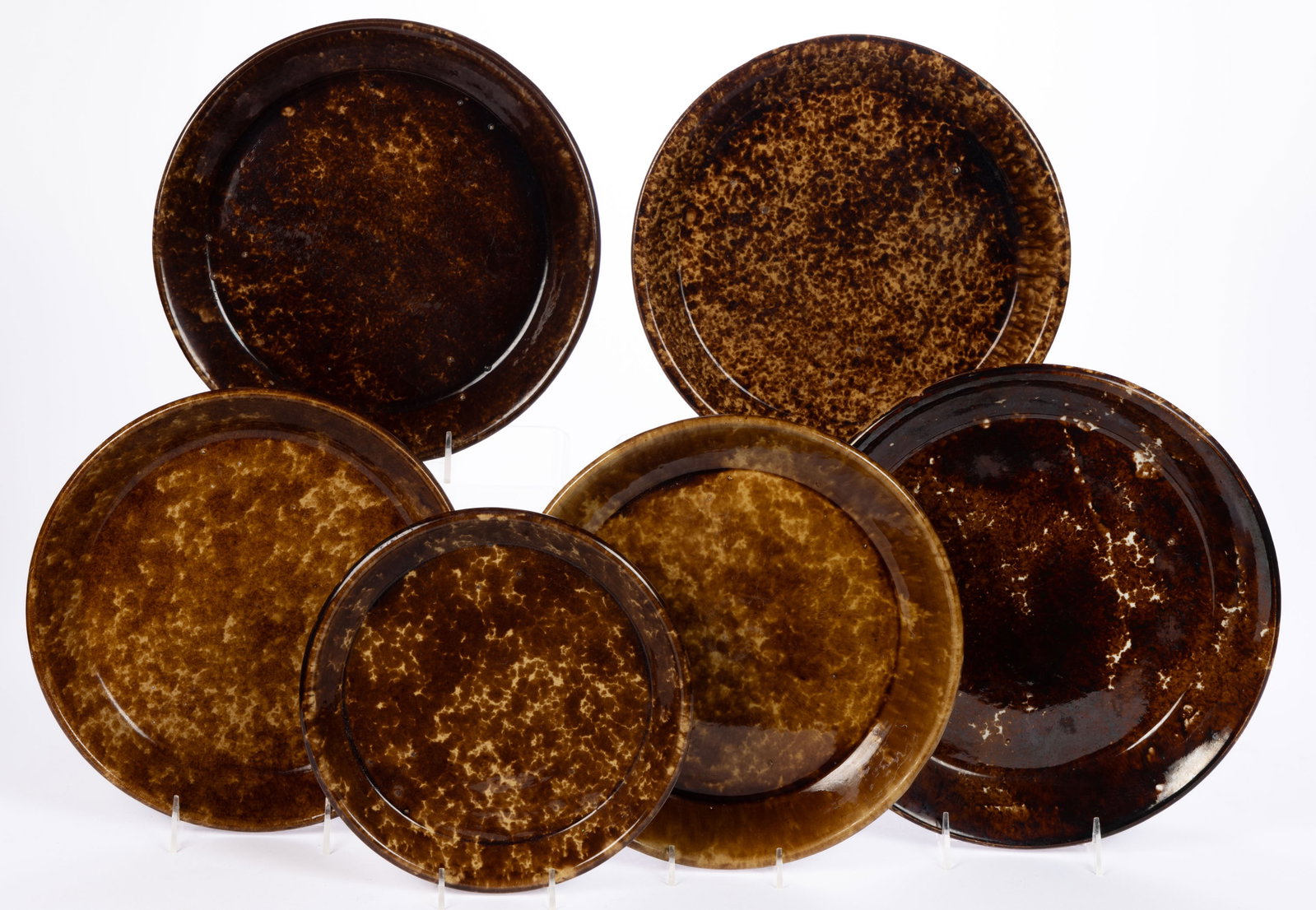 AMERICAN ROCKINGHAM-GLAZE POTTERY BAKERS / PANS, LOT OF SIX: AMERICAN ROCKINGHAM-GLAZE POTTERY BAKERS / PANS, LOT OF SIX, mottled brown glaze. Unmarked. 9 1/4" to 11 1/4" D rim. Provenance: From the William D. Annable estate, Oberlin, OH.