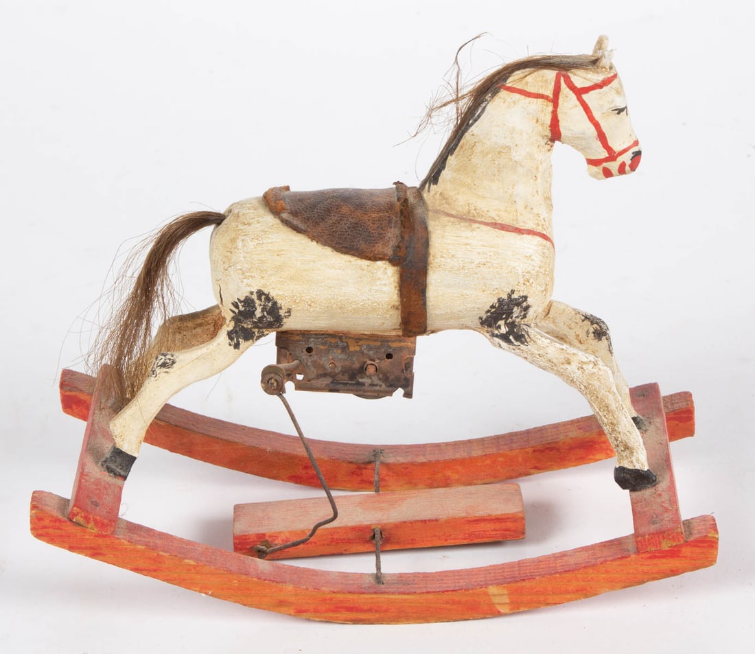 GERMAN ROCKING HORSE WIND-UP TOY: GERMAN ROCKING HORSE WIND-UP TOY, horse made of wood and composition having painted features, applied hair, and a leather saddle, attached to wooden rockers, winding mechanism to underside o