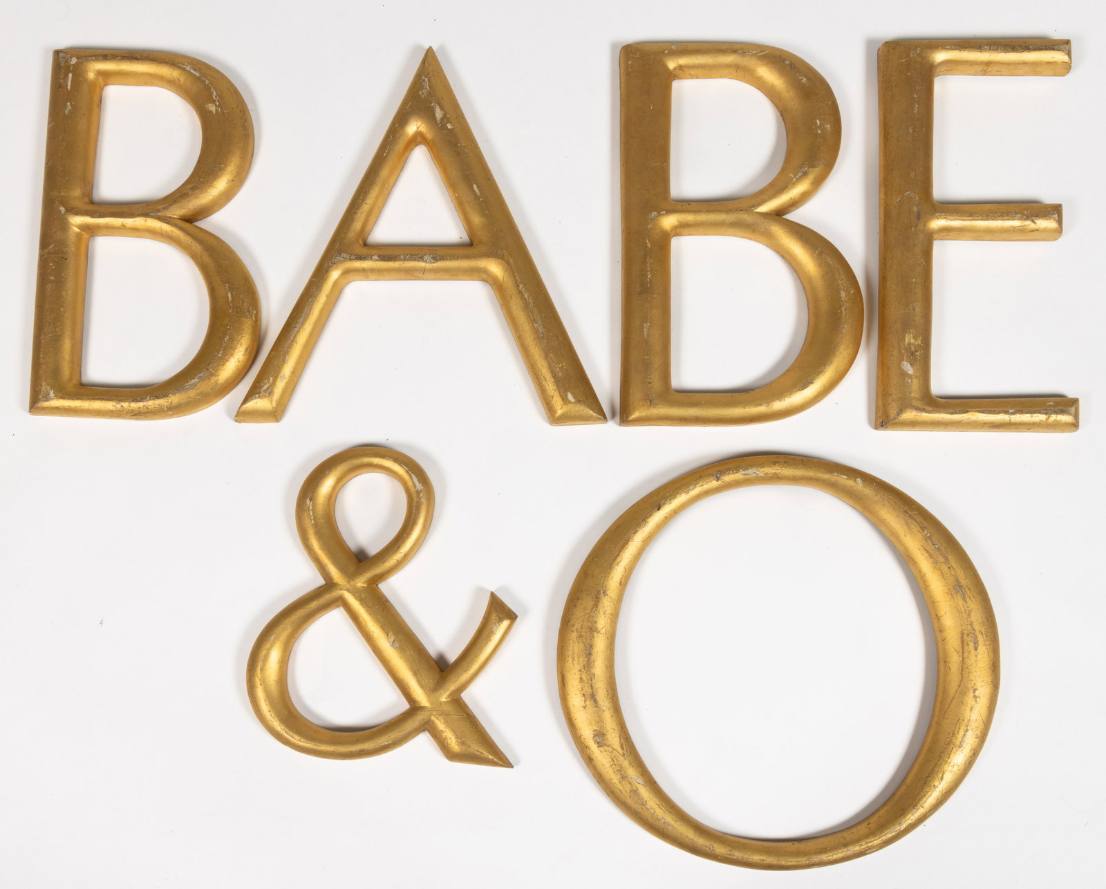AMERICAN GILTWOOD LETTERS / SYMBOL, LOT OF SIX: AMERICAN GILTWOOD LETTERS / SYMBOL, LOT OF SIX, each with a flat back and former mounting holes. Second half 20th century. 13" to 16" H. Provenance: From the William D. Annable estate, Oberl