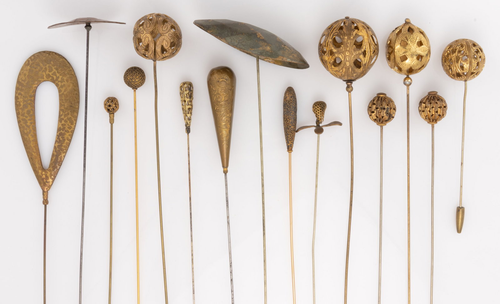 ANTIQUE / VINTAGE GOLD-FILLED AND OTHER METAL HATPINS, LOT OF 15: ANTIQUE / VINTAGE GOLD-FILLED AND OTHER METAL HATPINS, LOT OF 15, including seven gold-filled/gold-toned with openwork spherical tops featuring one pair, one with Arts and Crafts copper top, and 