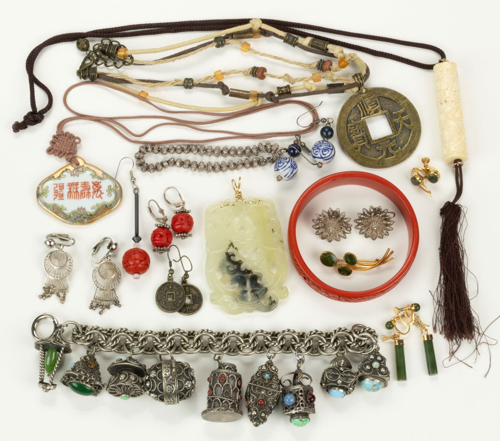 CHINESE / ASIAN-TYPE AND OTHER COSTUME JEWELRY, LOT OF 23 PIECES: CHINESE / ASIAN-TYPE AND OTHER COSTUME JEWELRY, LOT OF 23 PIECES, including a carved jade/nephrite pendant with gold-toned wire bail, two pairs of screw-back earrings and a brooch with jade/nephrite s