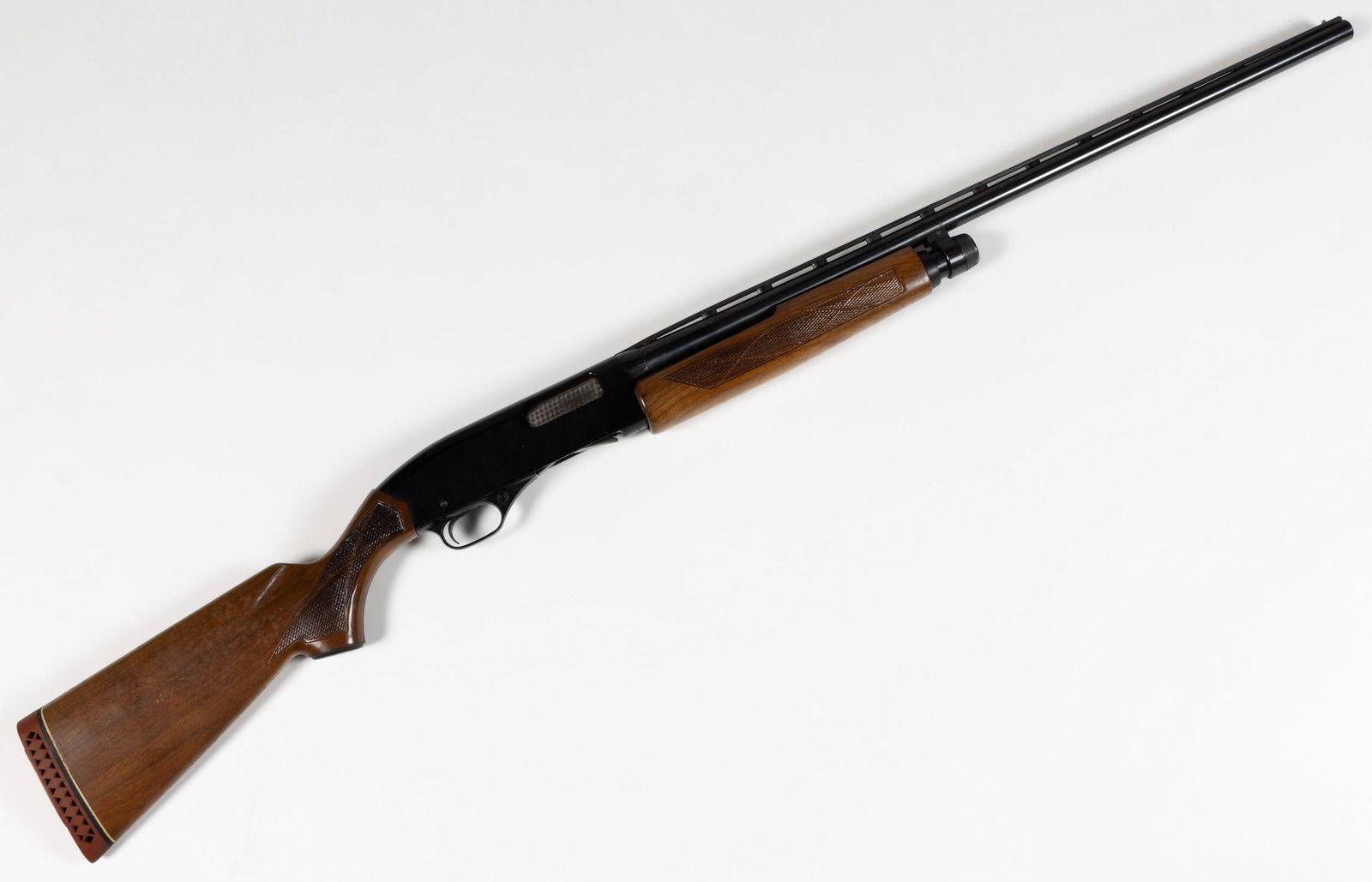 WINCHESTER MODEL 1200 PUMP-ACTION SHOTGUN: WINCHESTER MODEL 1200 PUMP-ACTION SHOTGUN, 20 gauge, vent-rib barrel, checkered walnut stock with recoil pad. Serial #L645458. Circa 1970. 48 1/2" LOA. Class: Modern. FIREARMS LAWS: All