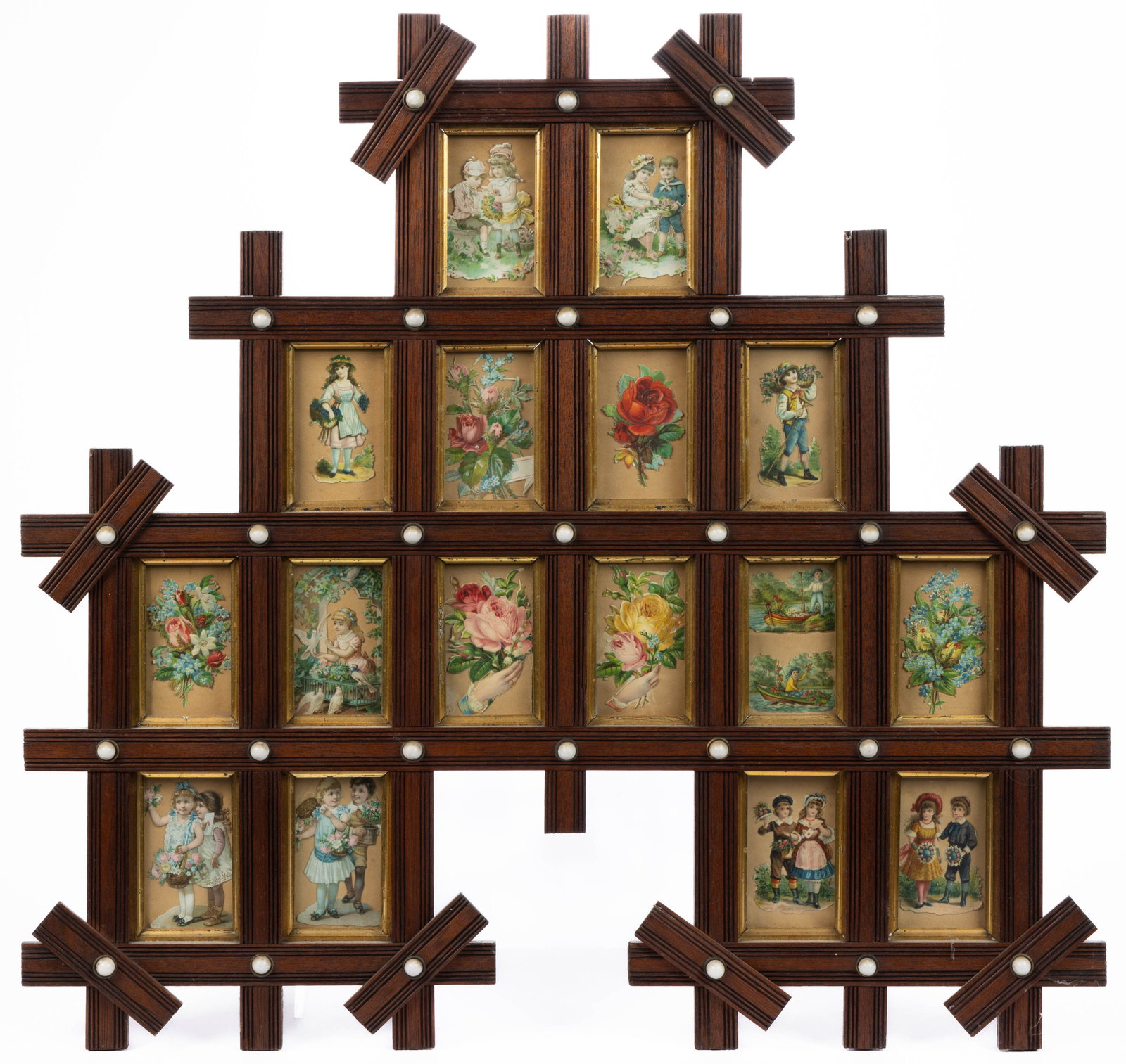 VICTORIAN MOLDED WALNUT CDV PICTURE FRAME: VICTORIAN MOLDED WALNUT CDV PICTURE FRAME, cross form with 16 gilt-lined openings for CDV photographs, frame set with porcelain buttons, currently housing lithograph die-cuts under glass. Retains an e