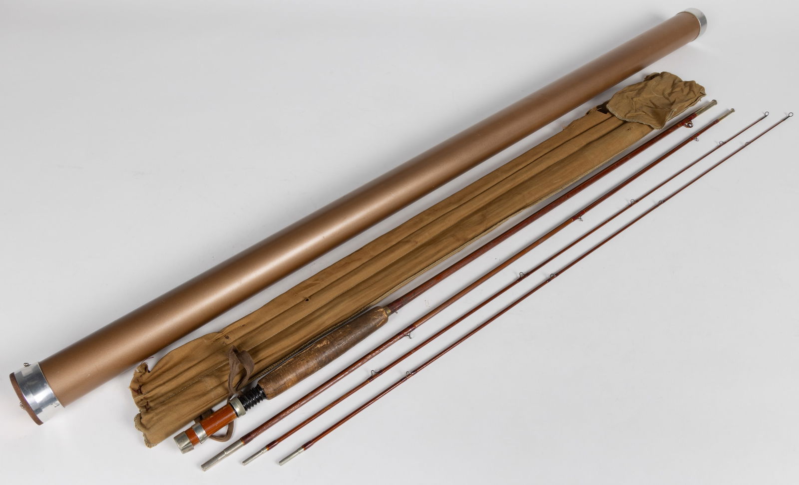 VINTAGE FOLSOM #515 BAMBOO FLY FISHING ROD: VINTAGE FOLSOM #515 BAMBOO FLY FISHING ROD, in three parts, the end section ion duplicate, cork grip, with original cloth case with wood guide and later metal hard case. Mid 20th century. 8 1/2&#