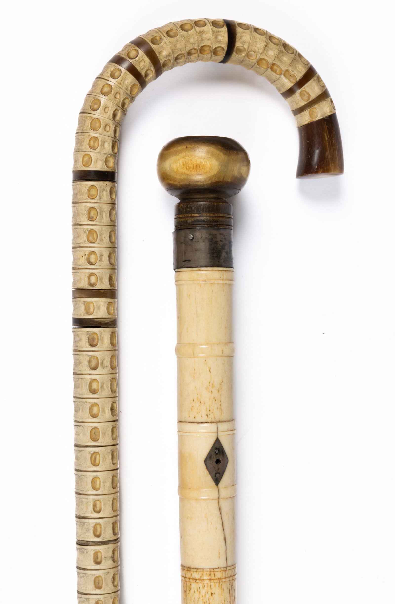 ASSORTED ANTIQUE BONE / VERTEBRA CANES / WALKING STICKS, LOT OF TWO: ASSORTED ANTIQUE BONE / VERTEBRA CANES / WALKING STICKS, LOT OF TWO, comprising a pieced example with horn spacers and grip, and a turned example with horn grip. Second half 19th century. 36" and