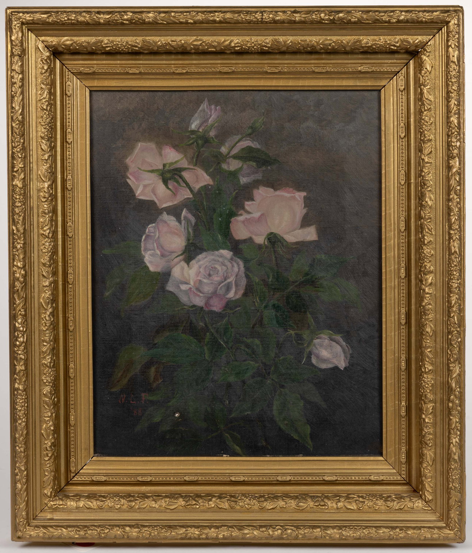 VICTORIAN AMERICAN SCHOOL (19TH CENTURY) STILL LIFE PAINTING: VICTORIAN AMERICAN SCHOOL (19TH CENTURY) STILL LIFE PAINTING, oil on canvas, depicting a bouquet of pink roses, signed "N.L.F. / '88" lower left. Housed in its original gold-painted gess