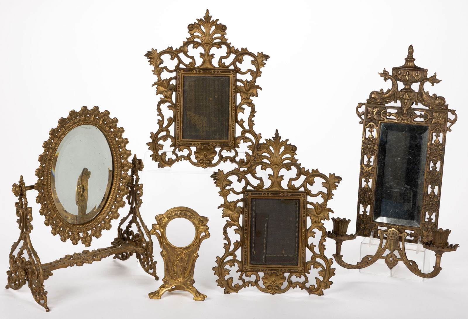 VICTORIAN CAST-IRON MIRRORS / FRAMES, LOT OF FOUR: VICTORIAN CAST-IRON MIRRORS / FRAMES, LOT OF FOUR, comprising a Bradley & Hubbard double-arm wall sconce with beveled mirror; a swivel dresser mirror with shamrocks surrounding the beveled mirror;