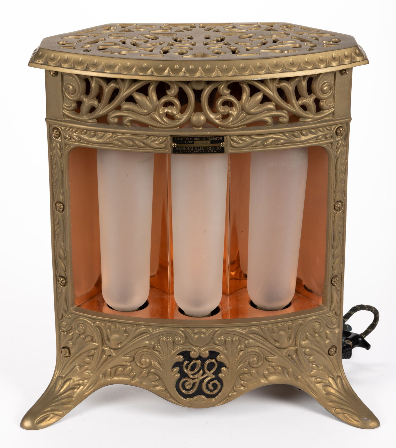 CAST-IRON GENERAL ELECTRIC (GE) LUMINOUS RADIATOR TYPE A29 HEATER: CAST-IRON GENERAL ELECTRIC (GE) LUMINOUS RADIATOR TYPE A29 HEATER, later gold paint, flat top with scalloped edge over an open-work scroll and feathered ornamentation, attached brass makers plaque mar