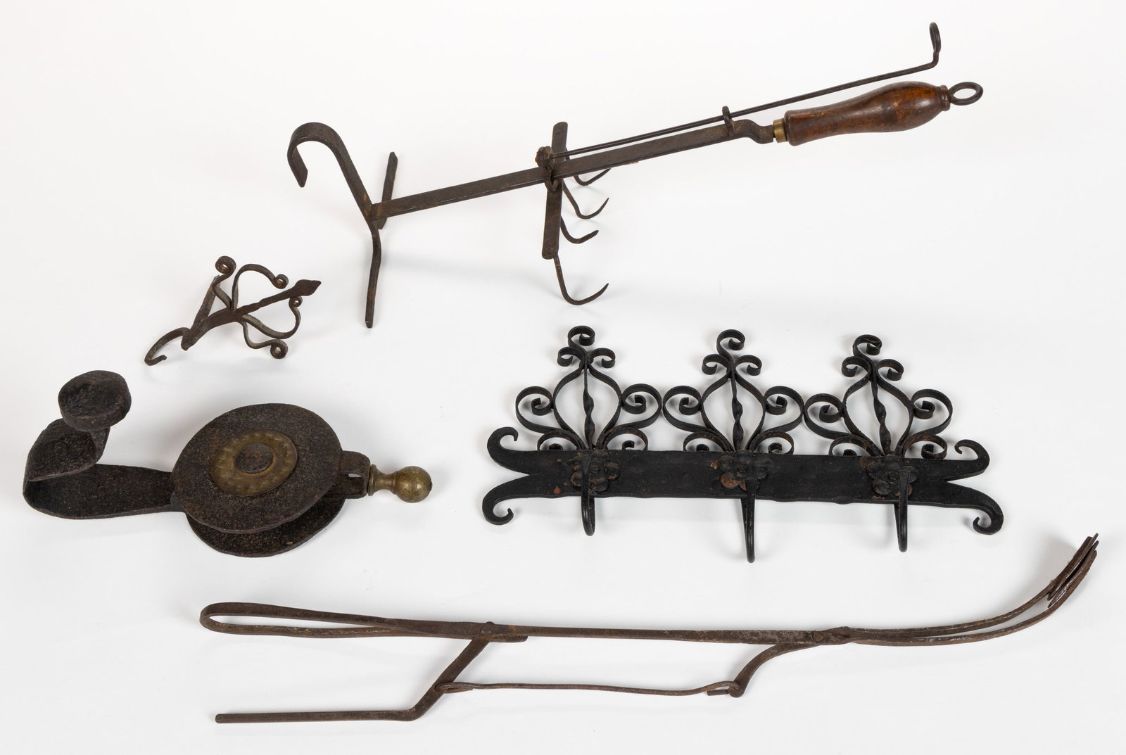ASSORTED WROUGHT-IRON / STEEL HEART ARTICLES, LOT OF FOUR: ASSORTED WROUGHT-IRON / STEEL HEART ARTICLES, LOT OF FOUR, comprising a pair of ember tongs, an adjustable bird roaster with fender hook and wooden handle, a spike-mount hanging hook with decorative t