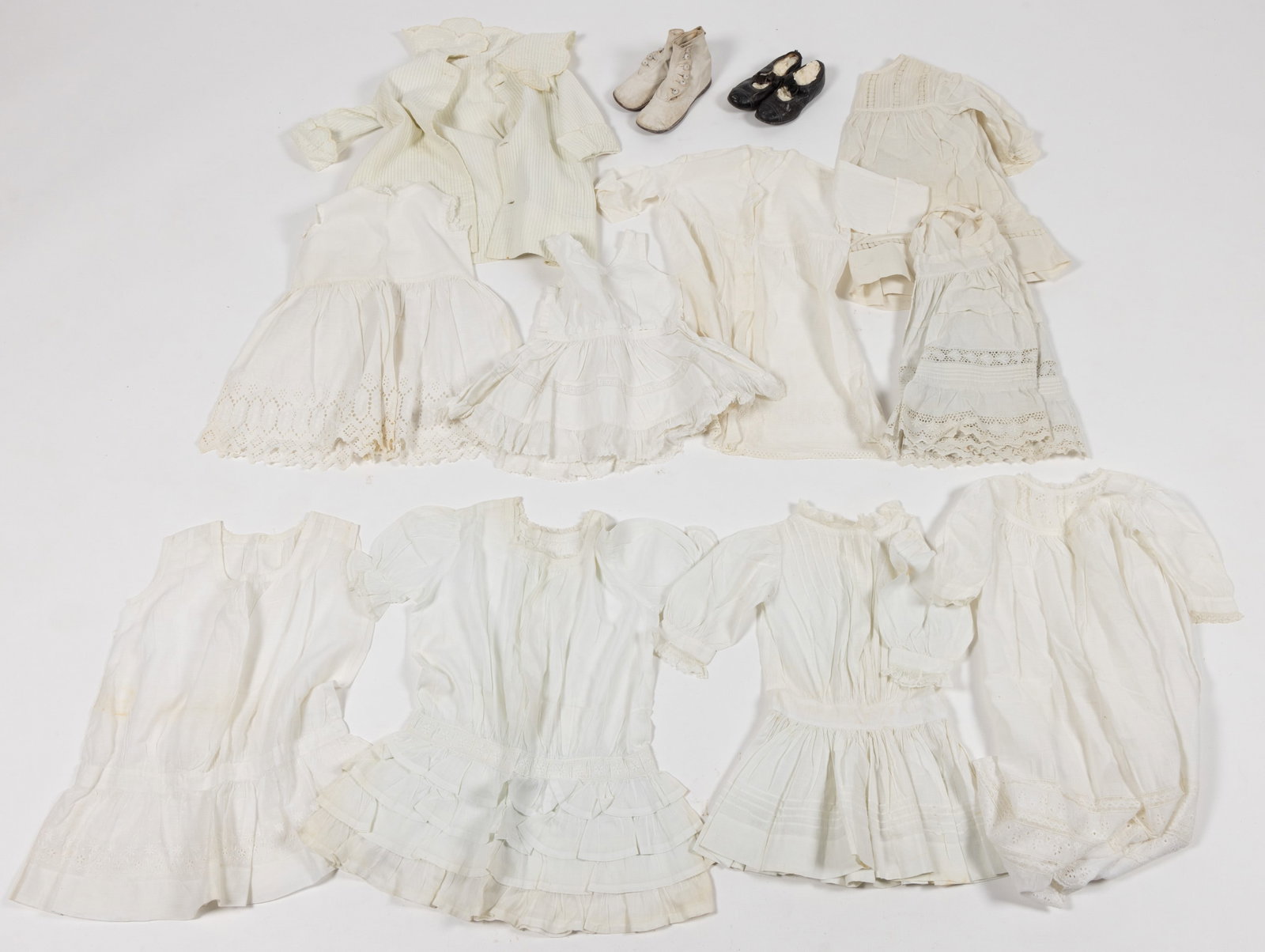 VICTORIAN AND ANTIQUE CHILDREN'S WHITE CLOTHING AND SHOES, LOT OF 14 PIECES: VICTORIAN AND ANTIQUE CHILDREN'S WHITE CLOTHING AND SHOES, LOT OF 14 PIECES, comprising a christening gown with lace, eyelet, and embroidered decoration, eight baby and child dresse