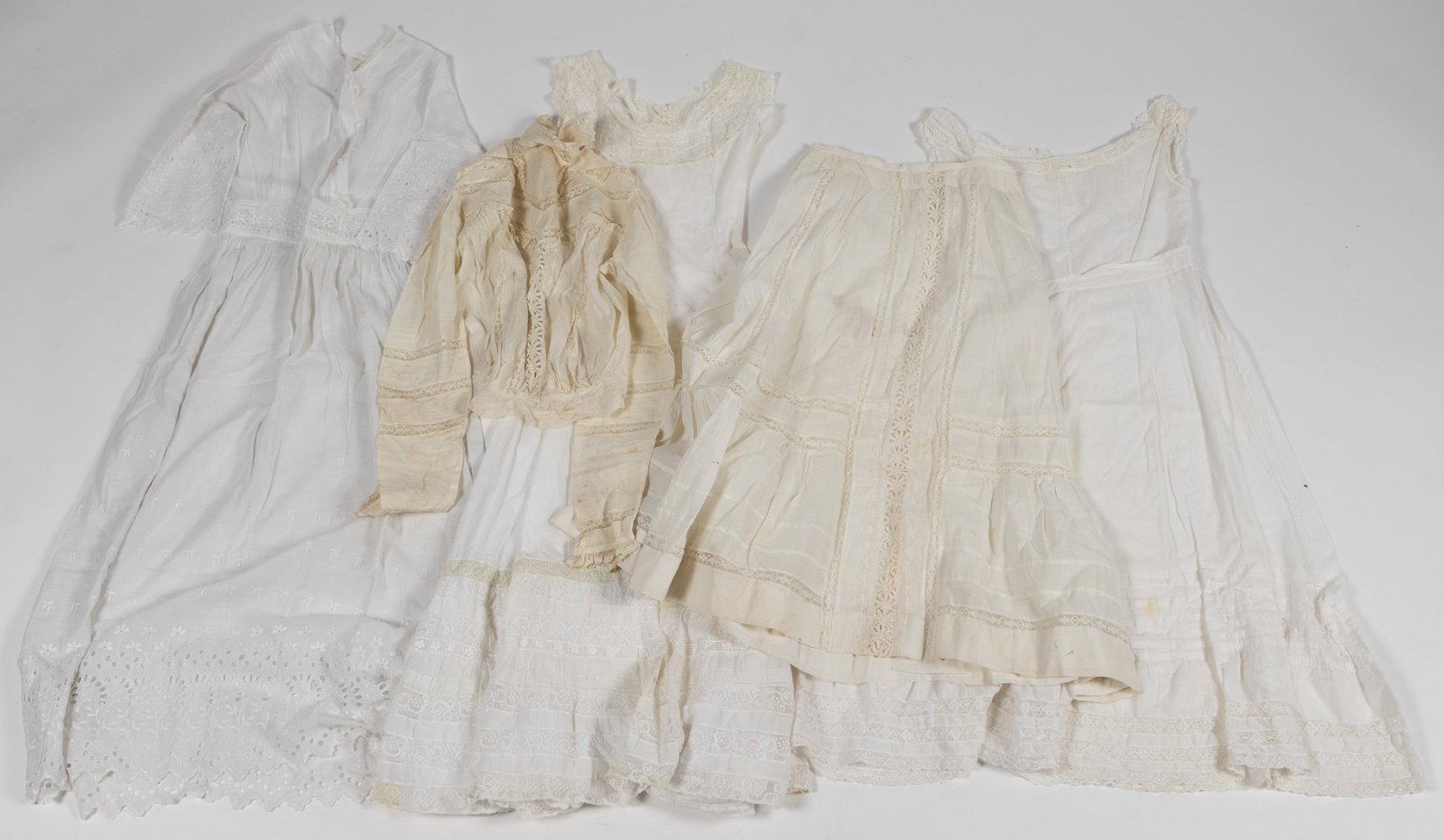 VICTORIAN / EDWARDIAN WHITE DRESSES AND OUTFIT, LOT OF FIVE PIECES: VICTORIAN / EDWARDIAN WHITE DRESSES AND OUTFIT, LOT OF FIVE PIECES, comprising a dress having eyelet and embroidered decoration with lace trim to bodice, two dresses / under dresses with lace acc