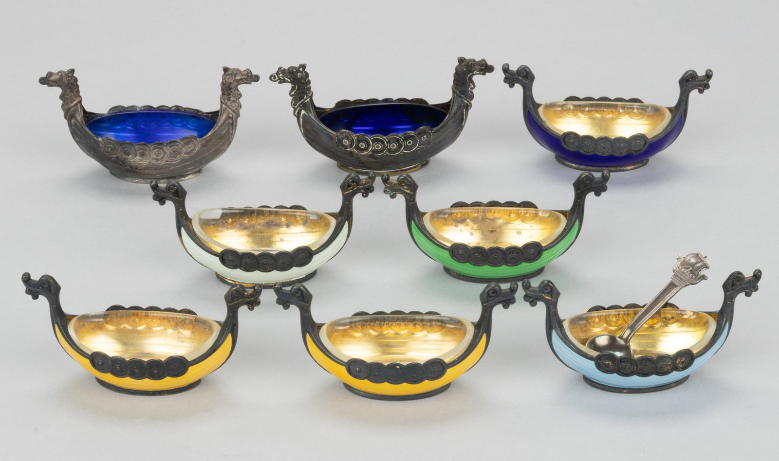 SCANDINAVIAN STERLING AND OTHER SILVER OPEN SALTS AND SALT SPOON, LOT OF NINE: SCANDINAVIAN STERLING AND OTHER SILVER OPEN SALTS AND SALT SPOON, LOT OF NINE, comprising a set of six Norwegian Viking ship sterling silver open salts by Magnus Aase of Bergen with each having enamel