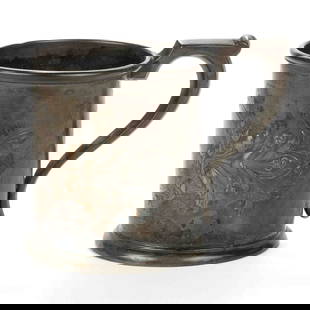 NORFOLK, VIRGINIA RETAILED, PHILADELPHIA, PENNSYLVANIA AESTHETIC MOVEMENT COIN SILVER MUG: NORFOLK, VIRGINIA RETAILED, PHILADELPHIA, PENNSYLVANIA AESTHETIC MOVEMENT COIN SILVER MUG, cylindrical form with Aesthetic repousse, chased, and engraved decoration to side, featuring foliat