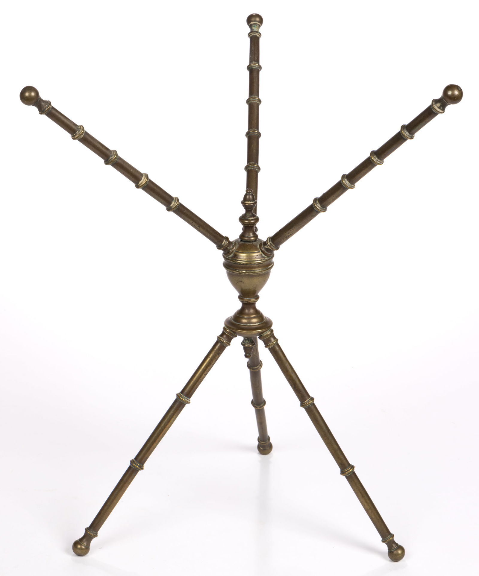 ENGLISH GEORGIAN BRASS TABLE CAT / DISH-WARMER: ENGLISH GEORGIAN BRASS TABLE CAT / DISH-WARMER, the urn-form swiveling center with finial and drop, supporting six removable ring-turned legs. Circa 1780. 16 1/4" HOA, 12 3/4" WOA.Literature