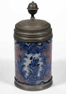 ENGLISH DELFT TIN-GLAZED STEIN / TANKARD: ENGLISH DELFT TIN-GLAZED STEIN / TANKARD, cylindrical form with pewter mounts and hinged lid, featuring blue hand-painted floral design framed by acanthus leaf decoration and powdered mangan