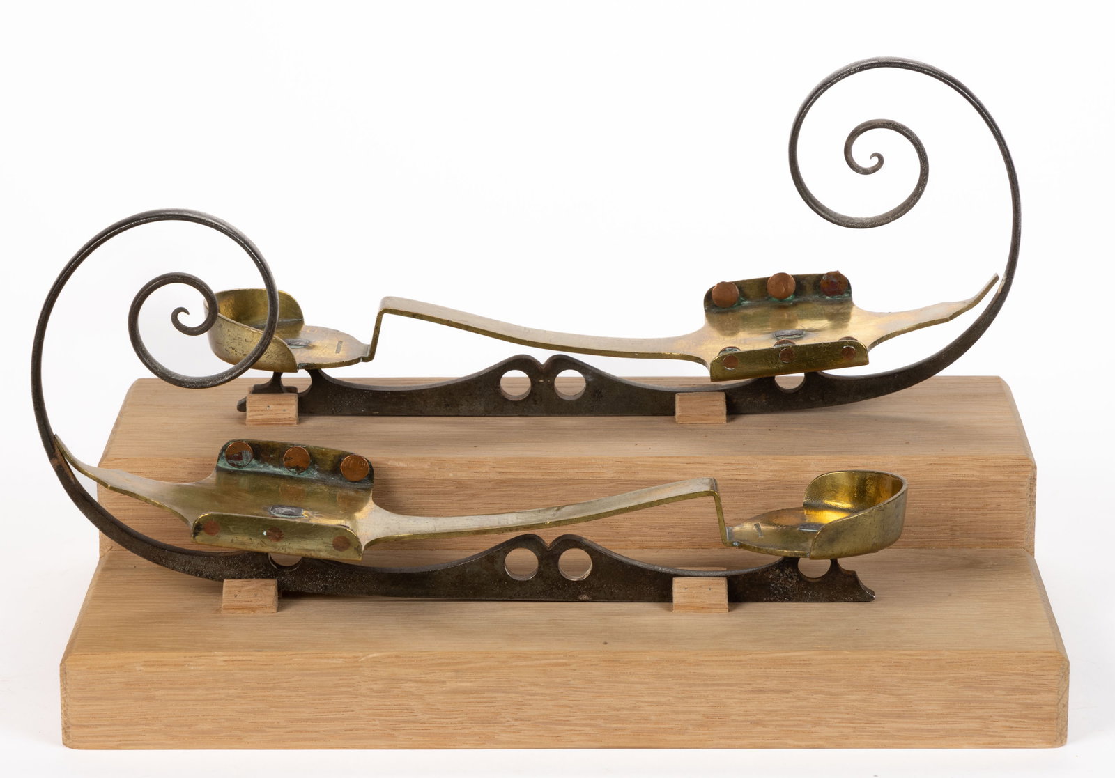 RARE SIGNED PAIR OF AMERICAN BRASS AND STEEL ICE SKATES: RARE SIGNED PAIR OF AMERICAN BRASS AND STEEL ICE SKATES, each with a shaped brass bed, stamped "T. J. ROBERTS" on the heel plate, set with copper tie-off rivets to inside of front plate and