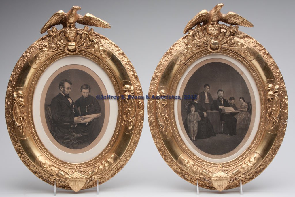 PAIR OF AMERICAN EAGLE PATRIOTIC PICTURE FRAMES: PAIR OF AMERICAN EAGLE PATRIOTIC PICTURE FRAMES, giltwood and gesso, each oval form surmounted by a spread-wing eagle on an orb, additional crossed weapons, cannons, flags, and a shield spaced around 
