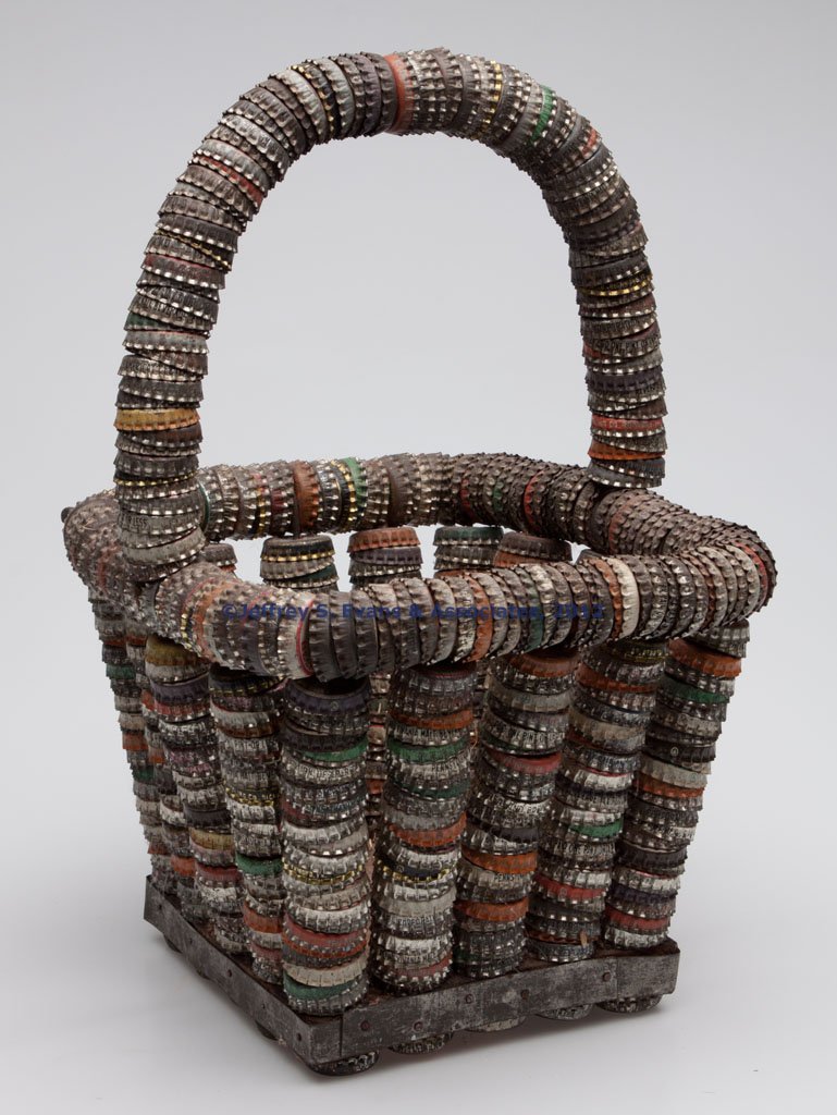 AMERICAN FOLK ART BOTTLE-CAP BASKET: AMERICAN FOLK ART BOTTLE-CAP BASKET, tapered square form with arched handle and wooden bottom, most caps appear to be from Virginia, Maryland and Pennsylvania. Probably Virginia or West Virginia. Firs