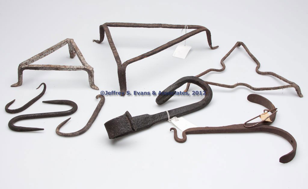 ASSORTED WROUGHT-IRON UTENSILS, LOT OF EIGHT: ASSORTED WROUGHT-IRON UTENSILS, LOT OF EIGHT, comprising three tri-corner trivets and five various hooks. 19th century. Hooks 4" to 9 1/2" L. Provenance: Property of a Valley of Virginia collector.