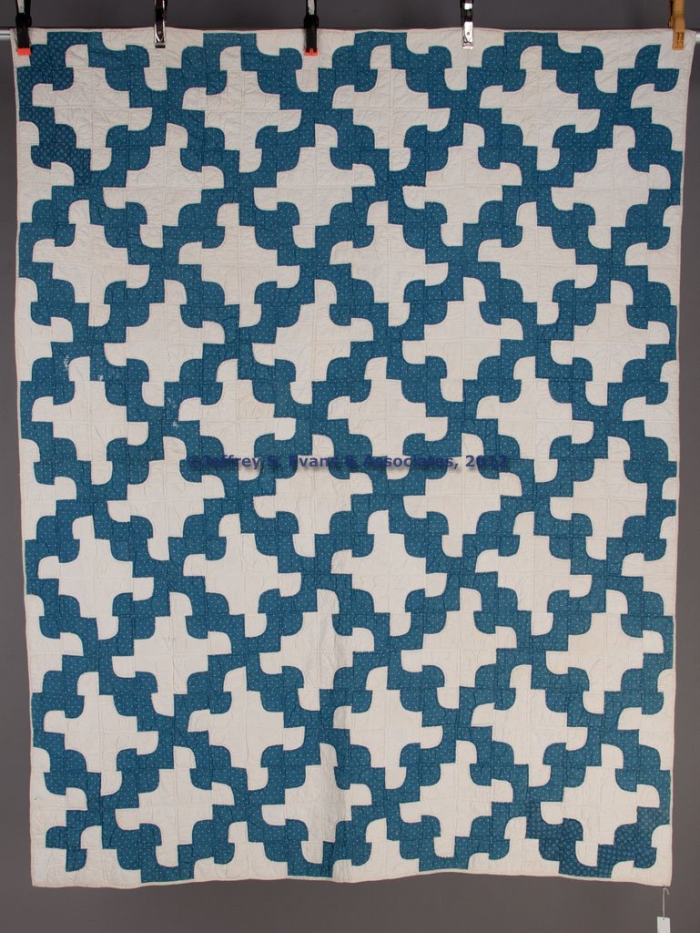 SHENANDOAH VALLEY OF VIRGINIA DRUNKARD'S PATH / RO: SHENANDOAH VALLEY OF VIRGINIA DRUNKARD'S PATH / ROCKY ROAD TO DUBLIN PATTERN PIECED QUILT, blue and white, outline and straight-line hand quilting. Second half 19th century. 64" x 80". Provenance: Bil
