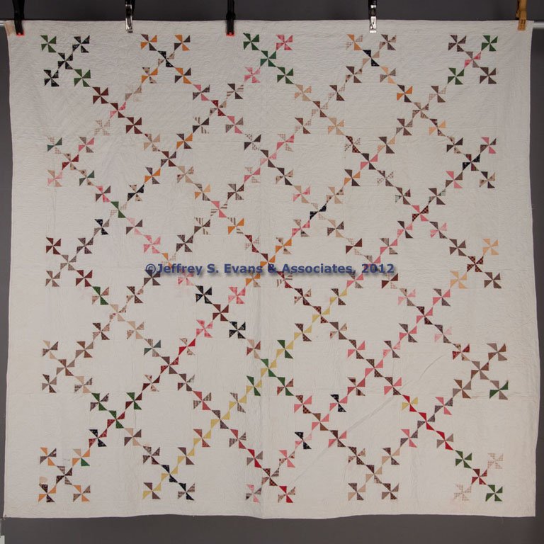 SHENANDOAH VALLEY OF VIRGINIA PINWHEEL PATTERN PIE: SHENANDOAH VALLEY OF VIRGINIA PINWHEEL PATTERN PIECED QUILT, comprising 81 blocks set alternately with unpieced blocks with album-type hand quilting, remaining quilting being straight-line. Second hal