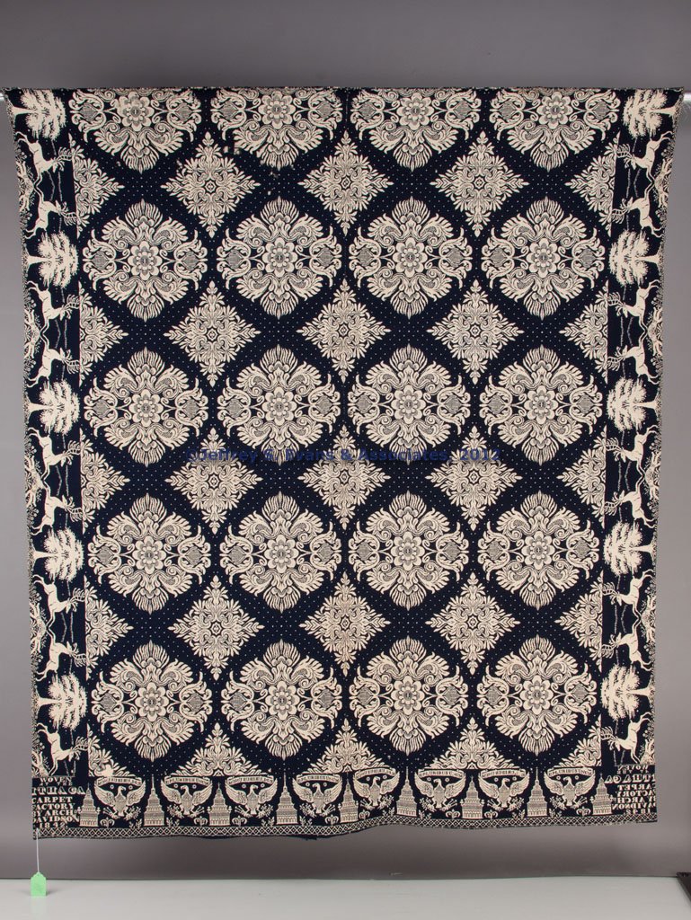 SIGNED ARCHD. DAVIDSON, NEW YORK JACQUARD COVERLET: SIGNED ARCHD. DAVIDSON, NEW YORK JACQUARD COVERLET, dark blue and white, two joined panels, floral medallion central design, running stag and tree side borders, American eagle and building end border,