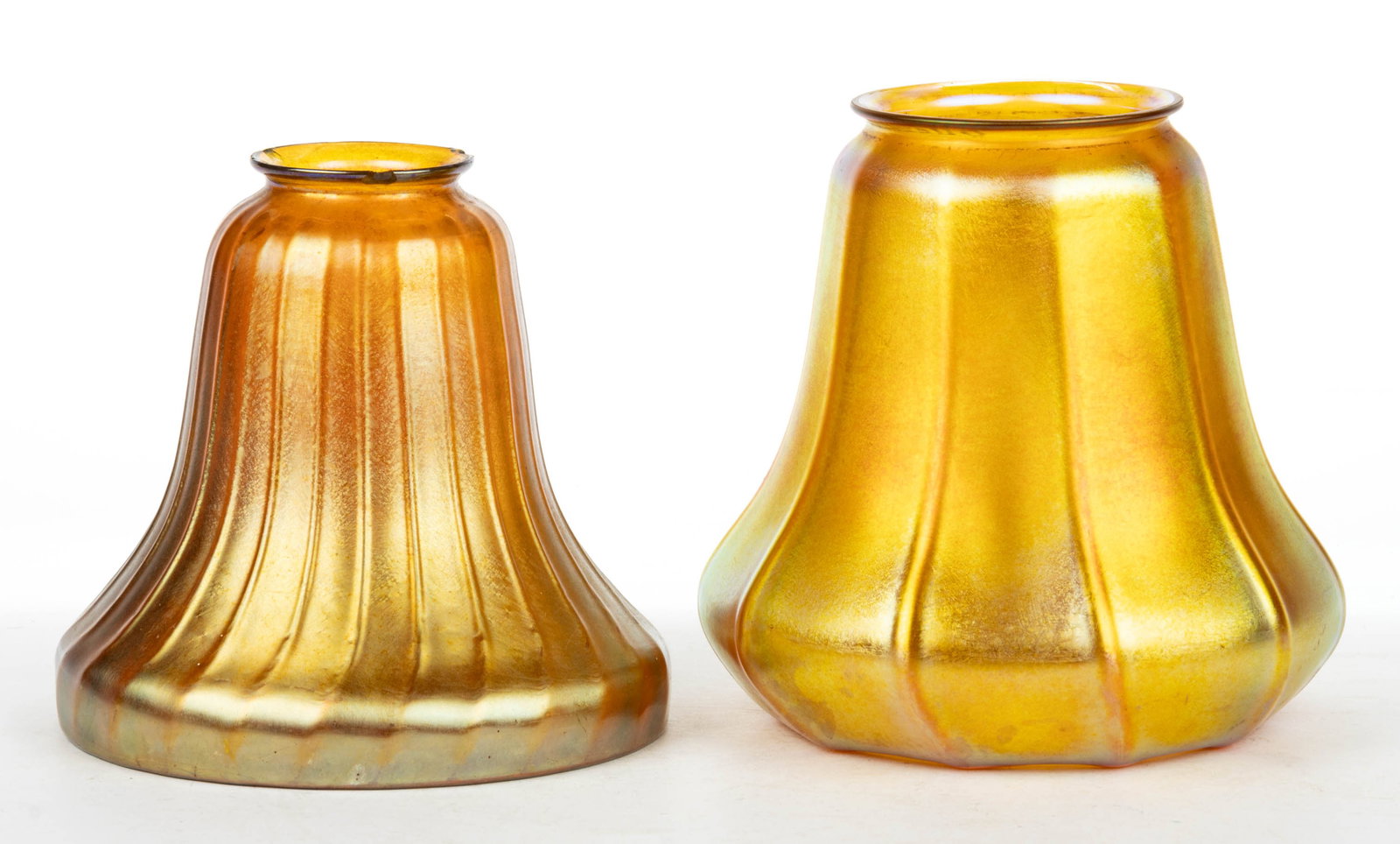GOLDEN IRIDESCENT ART GLASS LAMP SHADES, LOT OF TWO: GOLDEN IRIDESCENT ART GLASS LAMP SHADES, LOT OF TWO, golden iridescent, comprising two bell form examples with the larger example signed "QUEZAL", other having no signature. Various makers. 
