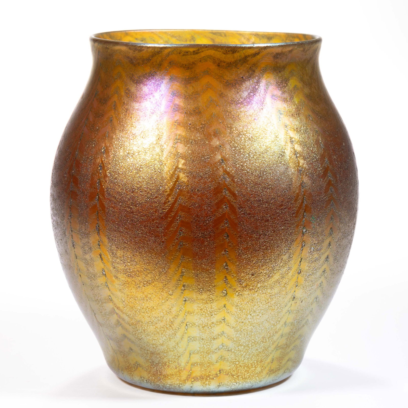 A. DOULAS NASH CHEVRON COLUMNS IRIDESCENT ART GLASS VASE: A. DOULAS NASH CHEVRON COLUMNS IRIDESCENT ART GLASS VASE, golden iridescent, bulbous form with eight paired columns of chevrons pointing upward, cypriote-type textured surface, signed to the base edge