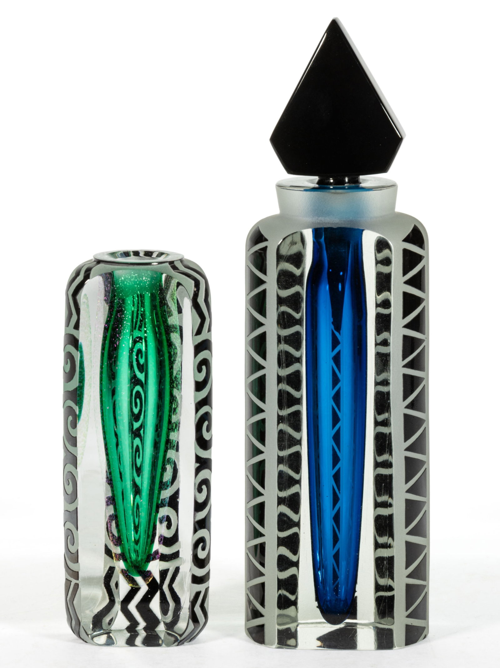 CORREIA STUDIO GLASS COLOGNES, LOT OF TWO: CORREIA STUDIO GLASS COLOGNES, LOT OF TWO, each of tall triangular form with sandblasted designs to the corners and polished sides, one retains its original stopper, each signed and numbered under the