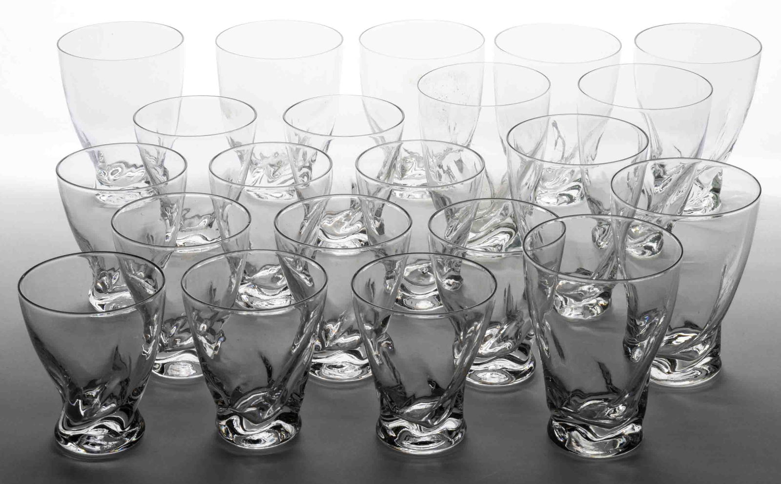 RUSSEL WRIGHT FLAME MID-CENTURY MODERN DRINKING ARTICLES, LOT OF 21: RUSSEL WRIGHT FLAME MID-CENTURY MODERN DRINKING ARTICLES, LOT OF 21, colorless, comprising ten goblets, and 11 wines. 20th century. 3 5/8" to 4 1/2" H. Provenance: From the collection of Ke