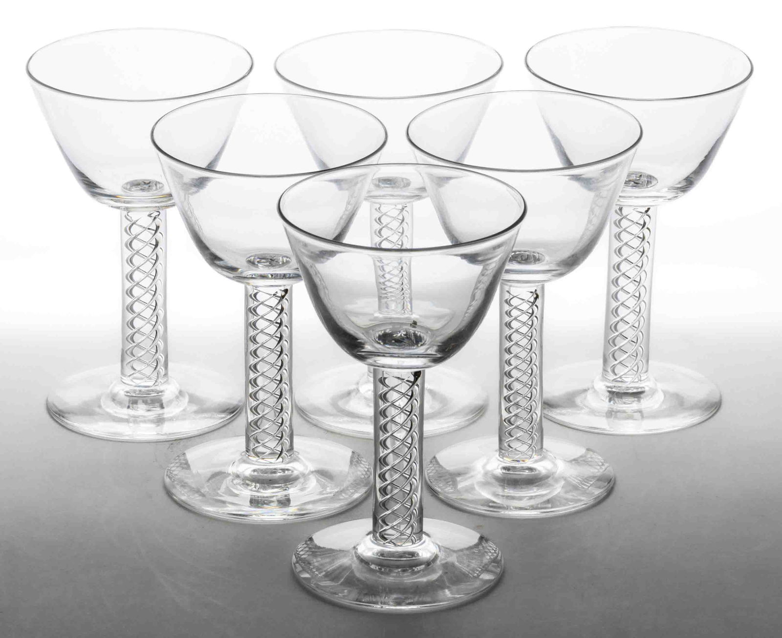 STEUBEN CRYSTAL NO. 8011 GLASS SHERRY GLASSES, LOT OF SIX: STEUBEN CRYSTAL NO. 8011 GLASS SHERRY GLASSES, LOT OF SIX, colorless, each having a conical bowl and an air-trap stem, each signed to the underside of the foot "Steuben", polished ponti