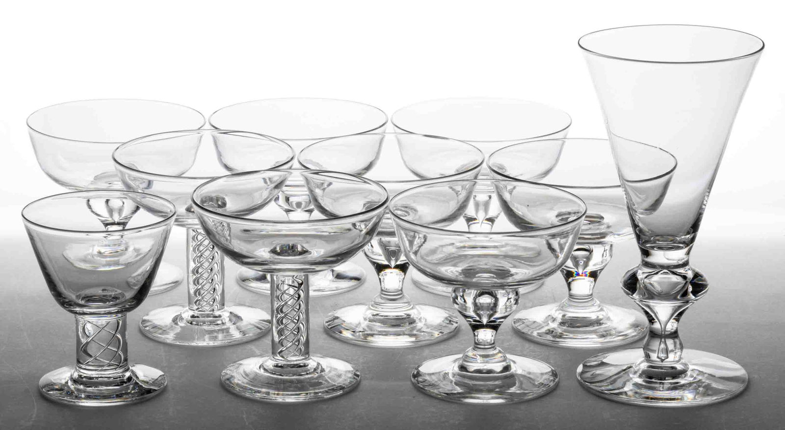 STEUBEN CRYSTAL GLASS DRINKING ARTICLES, LOT OF TEN: STEUBEN CRYSTAL GLASS DRINKING ARTICLES, LOT OF TEN, colorless, comprising a No. 7377 champagne flute, six No. 7877 champagnes, and two No. 8011 champagnes, and one No. 8011 wine, each signed to the u