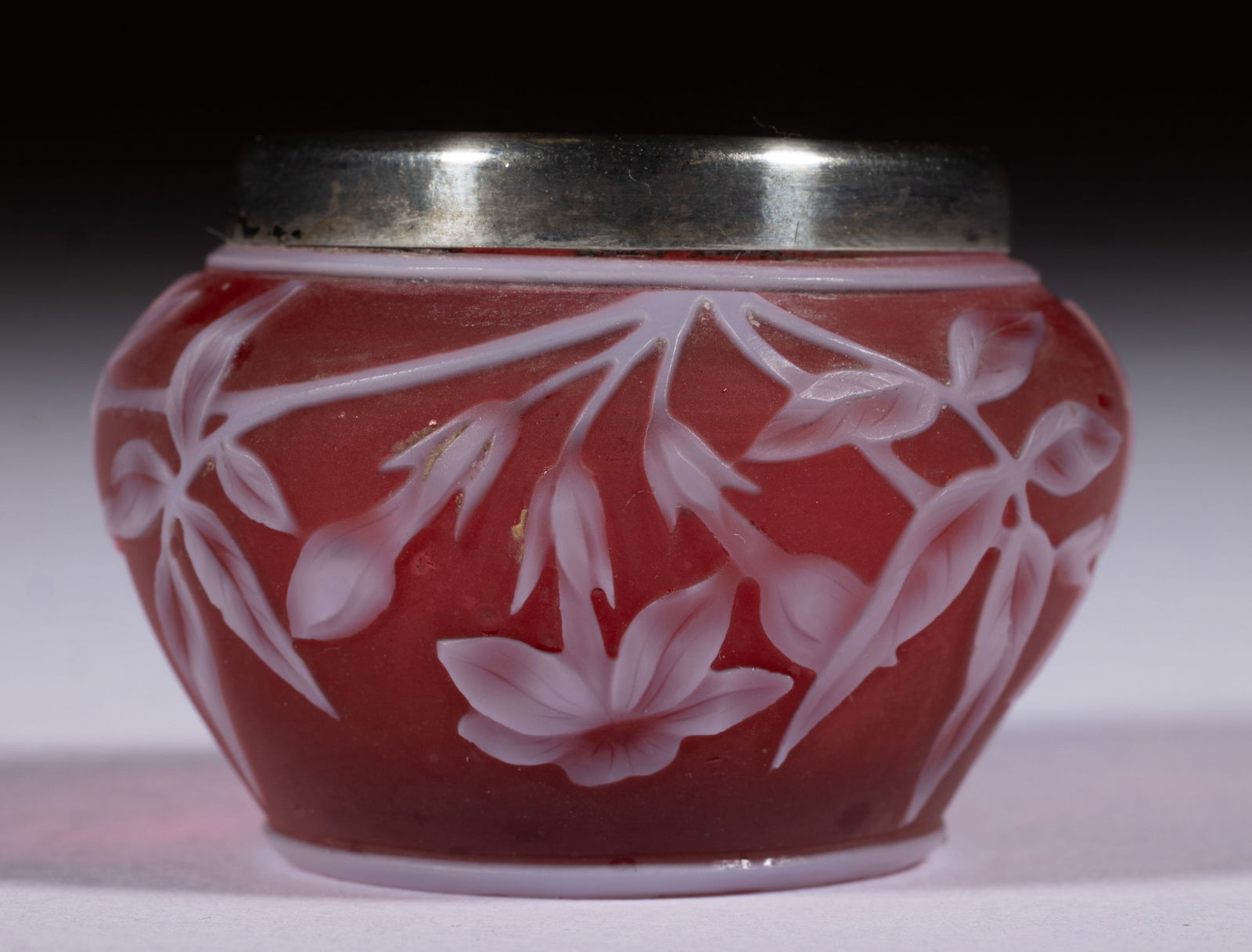 ENGLISH CAMEO ART GLASS OPEN SALT: ENGLISH CAMEO ART GLASS OPEN SALT, white to red, squat form with trumpet flowers with flanking leaves, applied silver rim with hallmarks, polished pontil mark. Stevens & Williams or Thomas Webb &a