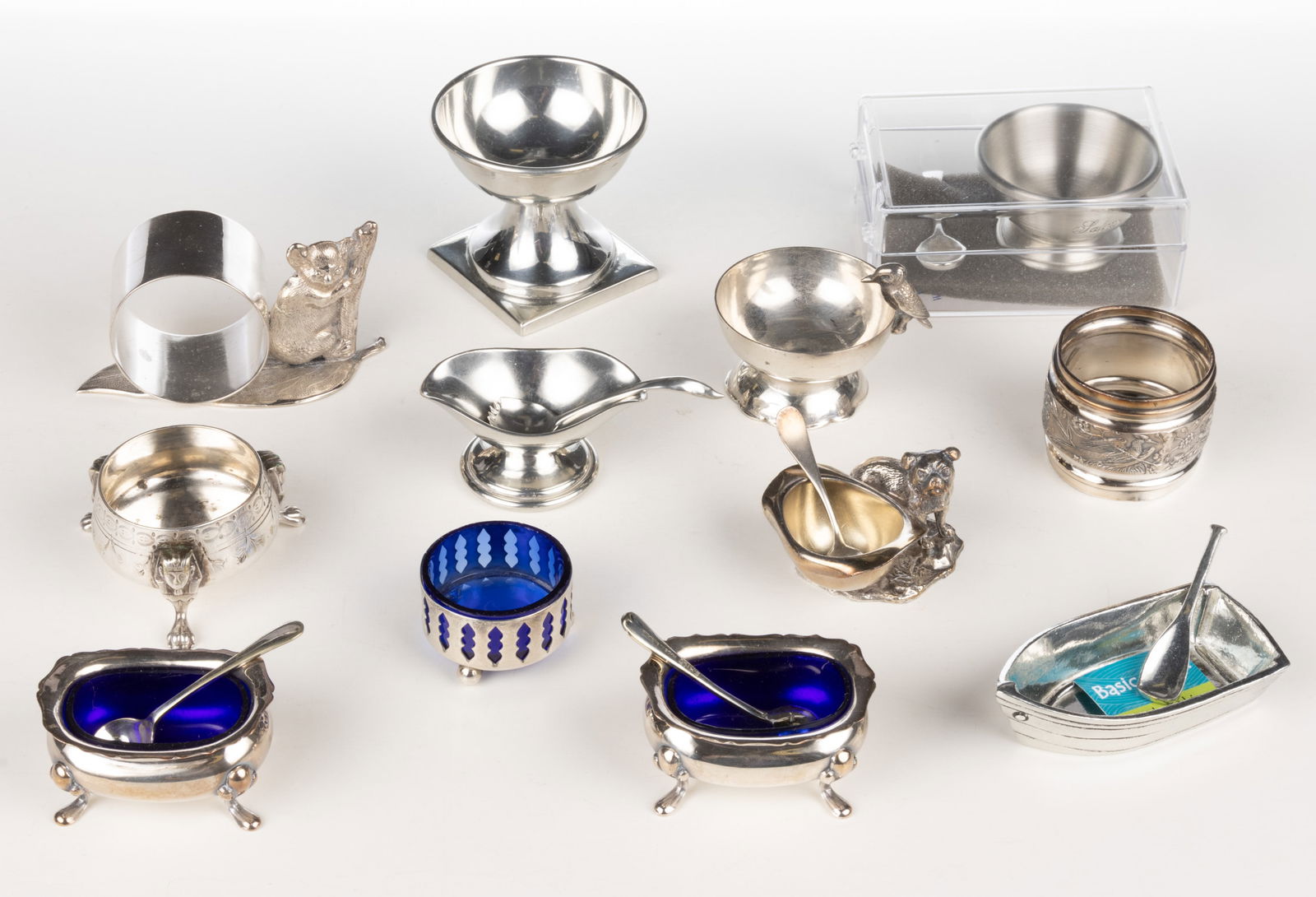 ASSORTED SILVER-PLATED, PEWTER, AND METAL OPEN SALTS, SALT SPOONS, AND NAPKIN RINGS, LOT OF 18 (1 of 1)