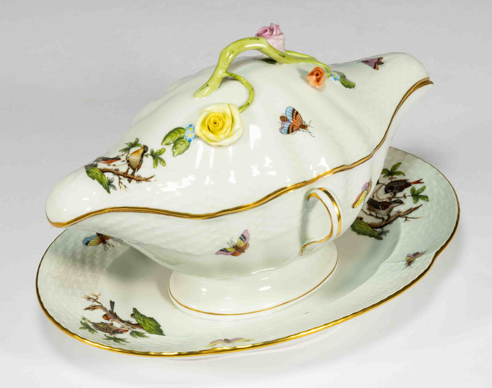 HUNGARIAN HEREND "ROTHSCHILD BIRD" PORCELAIN SAUCE BOAT WITH ATTACHED UNDERTRAY: HUNGARIAN HEREND "ROTHSCHILD BIRD" PORCELAIN SAUCE BOAT WITH ATTACHED UNDERTRAY, featuring polychrome hand-painted images of bird pairs with scattered butterflies and insects, molded basketw