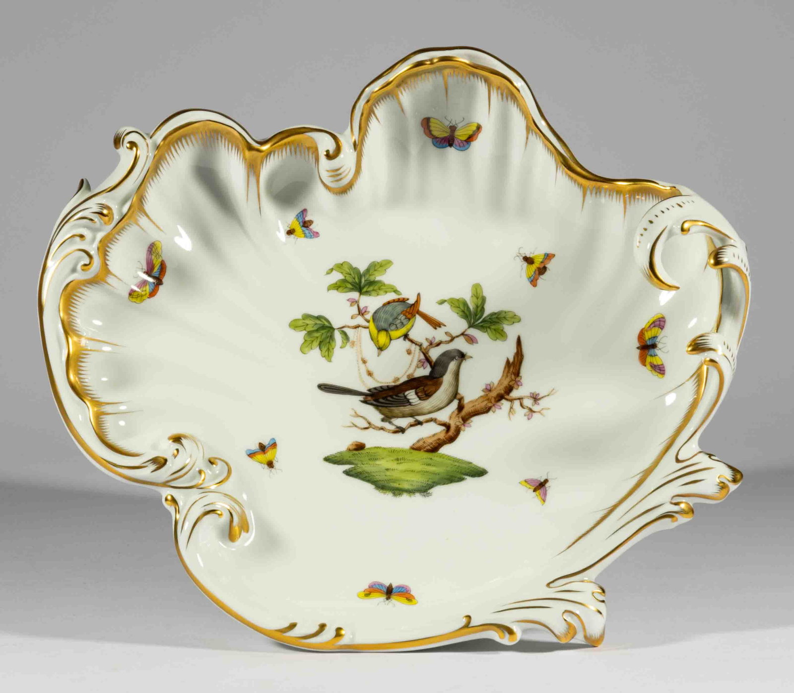 HUNGARIAN HEREND "ROTHSCHILD BIRD" PORCELAIN ROCOCO DISH: HUNGARIAN HEREND "ROTHSCHILD BIRD" PORCELAIN ROCOCO DISH, featuring polychrome hand-painted images of bird and scattered butterflies and insects having intricately gilt scalloped foliated ri