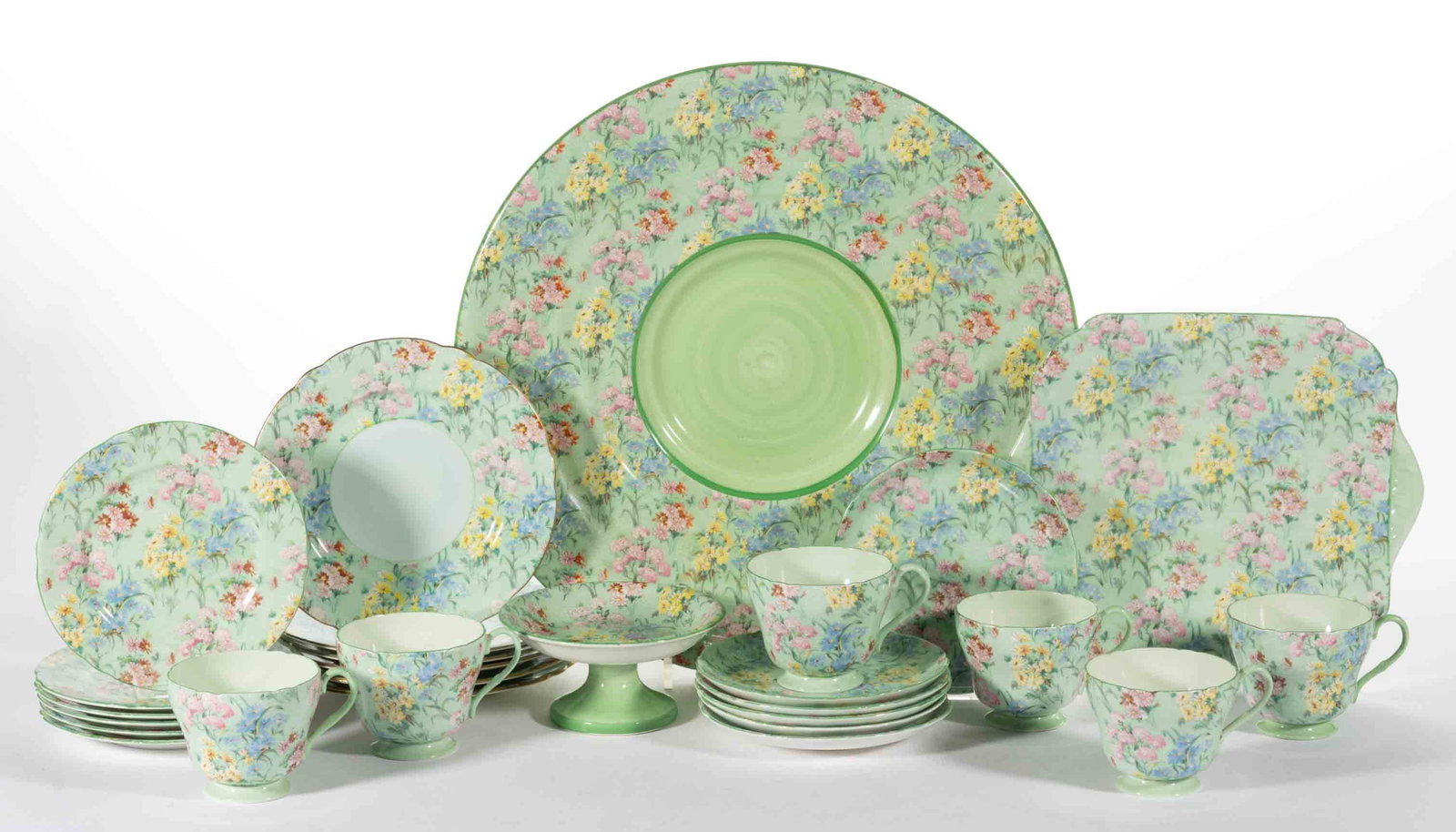 ENGLISH SHELLEY "MELODY" CERAMIC TEA AND TABLE ARTICLES, LOT OF 27: ENGLISH SHELLEY "MELODY" CERAMIC TEA AND TABLE ARTICLES, LOT OF 27, each featuring a charming polychrome floral transfer design on light green, including a 14 3/8" D plaque with th
