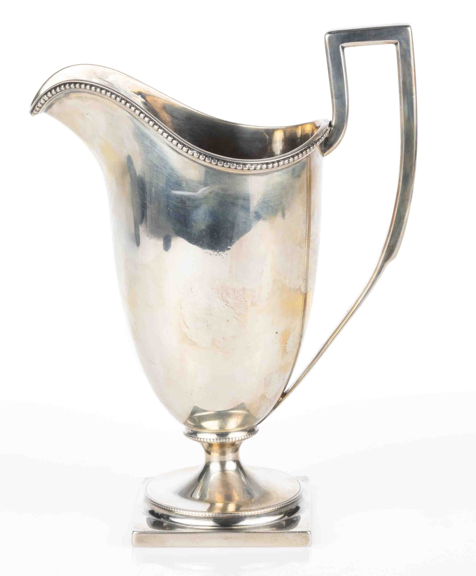 PHILADELPHIA, PENNSYLVANIA NEOCLASSICAL-STYLE STERLING SILVER CREAMER: PHILADELPHIA, PENNSYLVANIA NEOCLASSICAL-STYLE STERLING SILVER CREAMER, tall helmet-form well with beaded rim and a hammer-textured interior, applied an angular handle, raised on a square base with rou