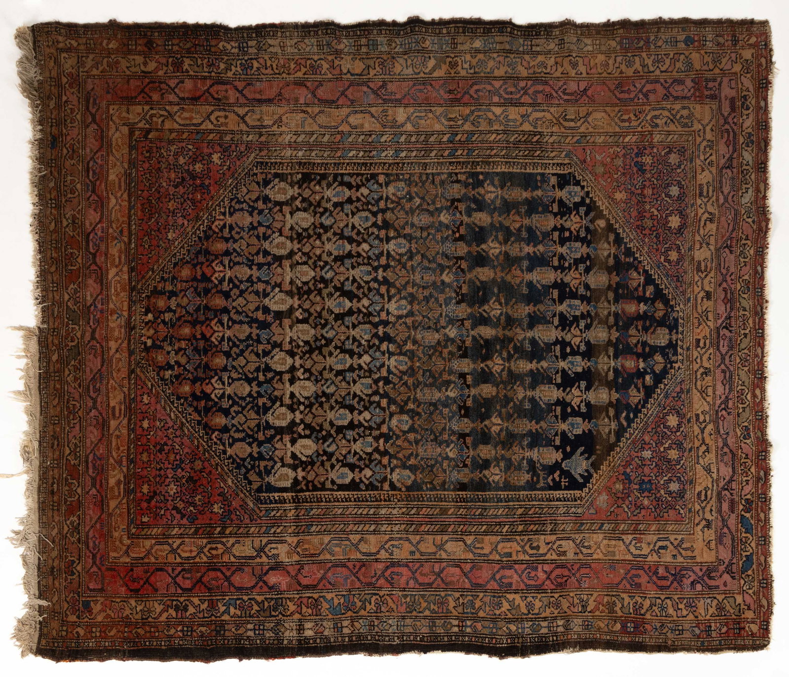 ANTIQUE TRIBAL RUG: ANTIQUE TRIBAL RUG, a navy field with an allover design, within an ivory border with stylized floral pattern. First half 20th century. 4' 10" x 7' 7". Provenance: