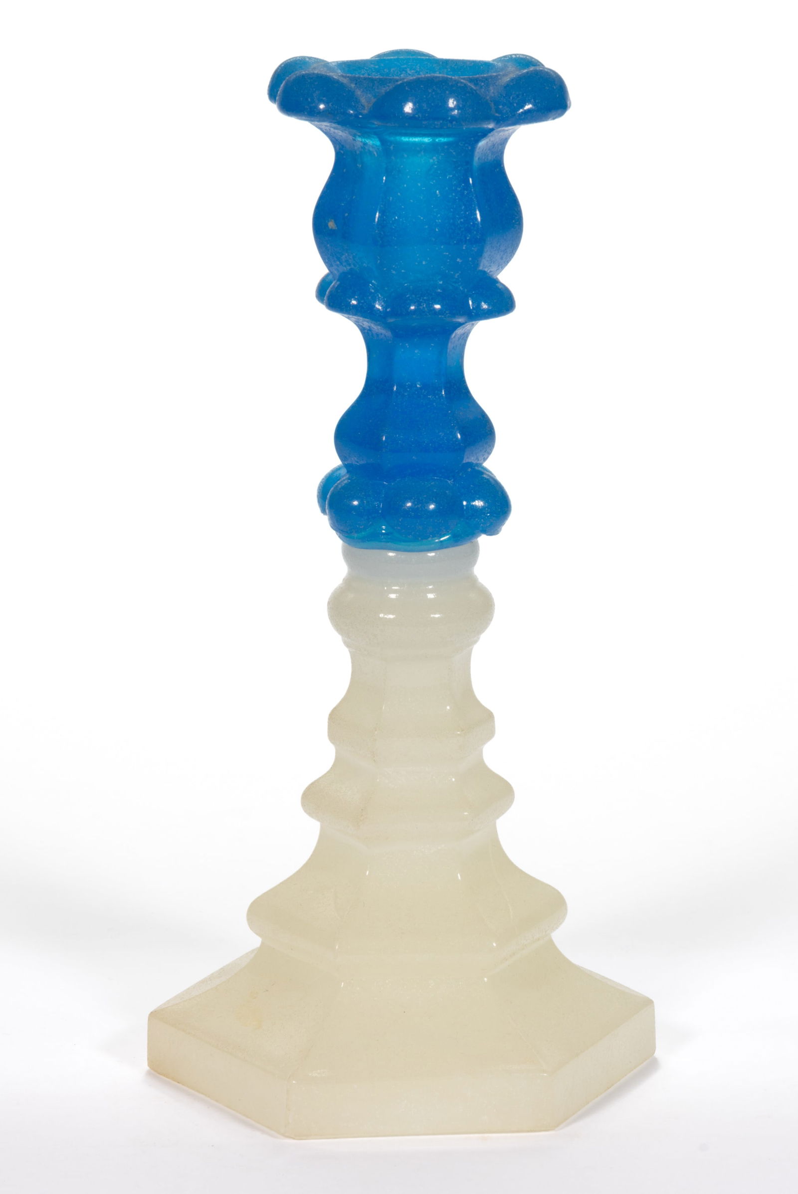 PRESSED PETAL AND HEXAGONAL CANDLESTICK: PRESSED PETAL AND HEXAGONAL CANDLESTICK, translucent starch blue above alabaster/clambroth with a lightly sanded surface, six-petal socket with reinforcing inner ring and lower extension having tipped