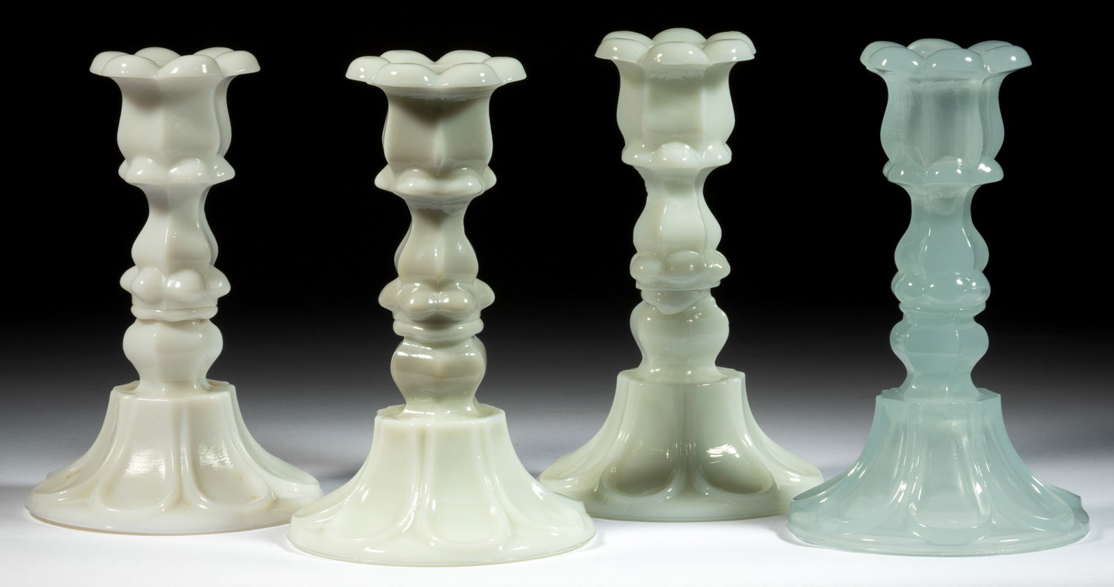 PRESSED PETAL AND LOOP CANDLESTICKS, LOT OF FOUR: PRESSED PETAL AND LOOP CANDLESTICKS, LOT OF FOUR, comprising three opaque white and one alabaster/clambroth, each having a six-petal socket with a hexagonal extension, raised on a hexagonal knop and s