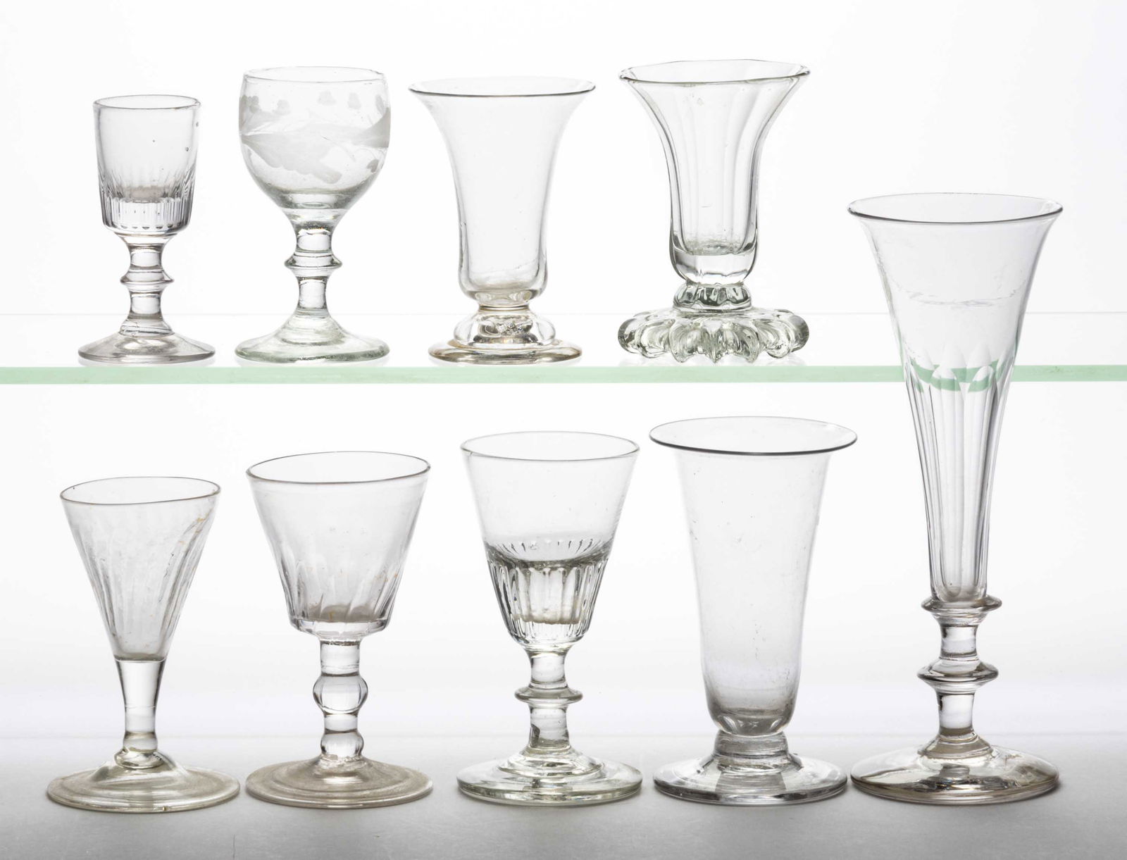 ASSORTED BLOWN GLASS DRINKING VESSELS, LOT OF NINE: ASSORTED BLOWN GLASS DRINKING VESSELS, LOT OF NINE, colorless glass, four vertically-ribbed pattern molded / pillar molded examples, two cut and fluted, one engraved, others unpatterned. Includin