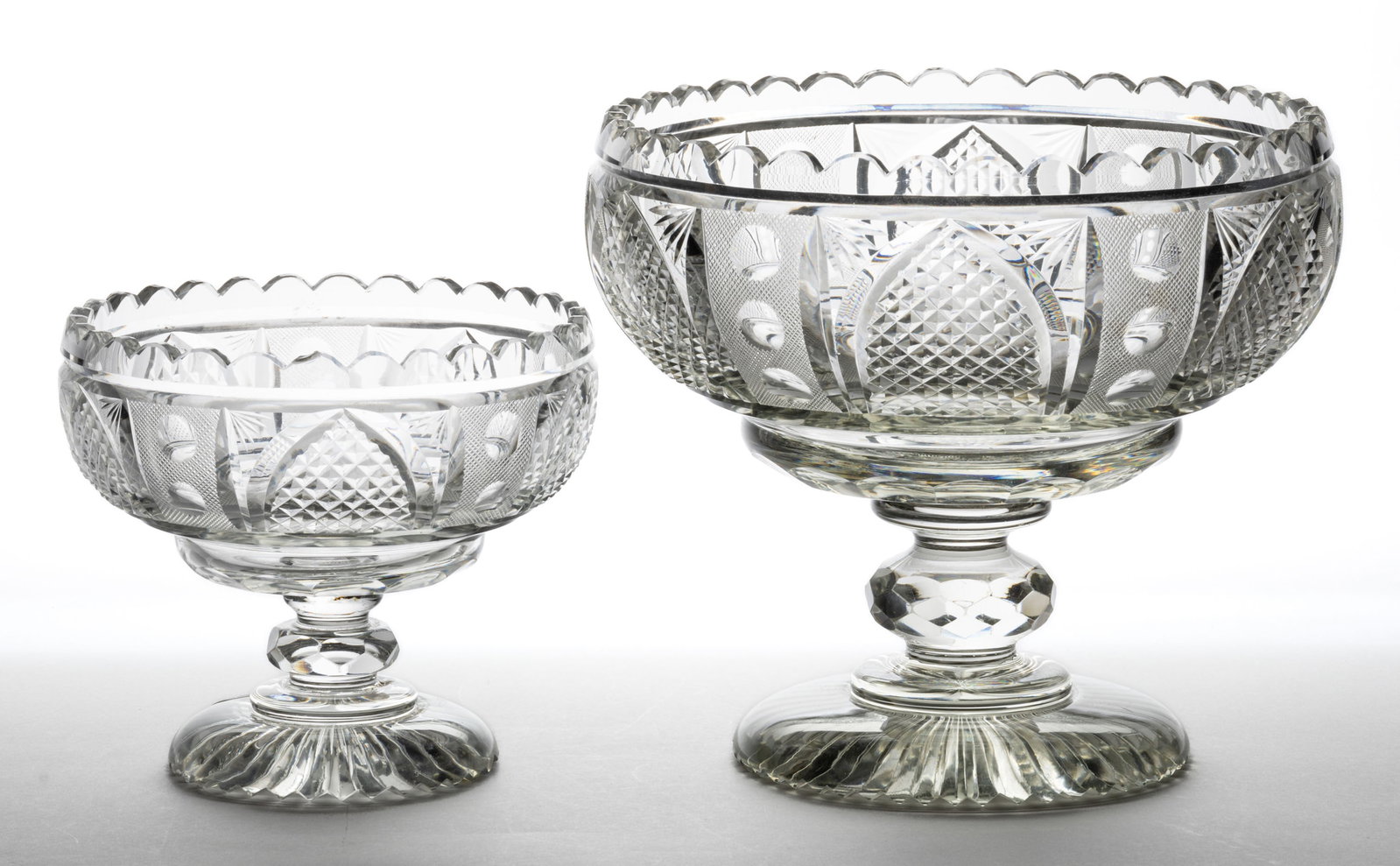 EARLY CUT GOTHIC ARCHES AND PUNTIES GLASS OPEN COMPOTES, LOT OF TWO: EARLY CUT GOTHIC ARCHES AND PUNTIES GLASS OPEN COMPOTES, LOT OF TWO, colorless lead glass, matching examples comprised of a small and large size, each featuring Gothic Arches with diamond cuts to the 