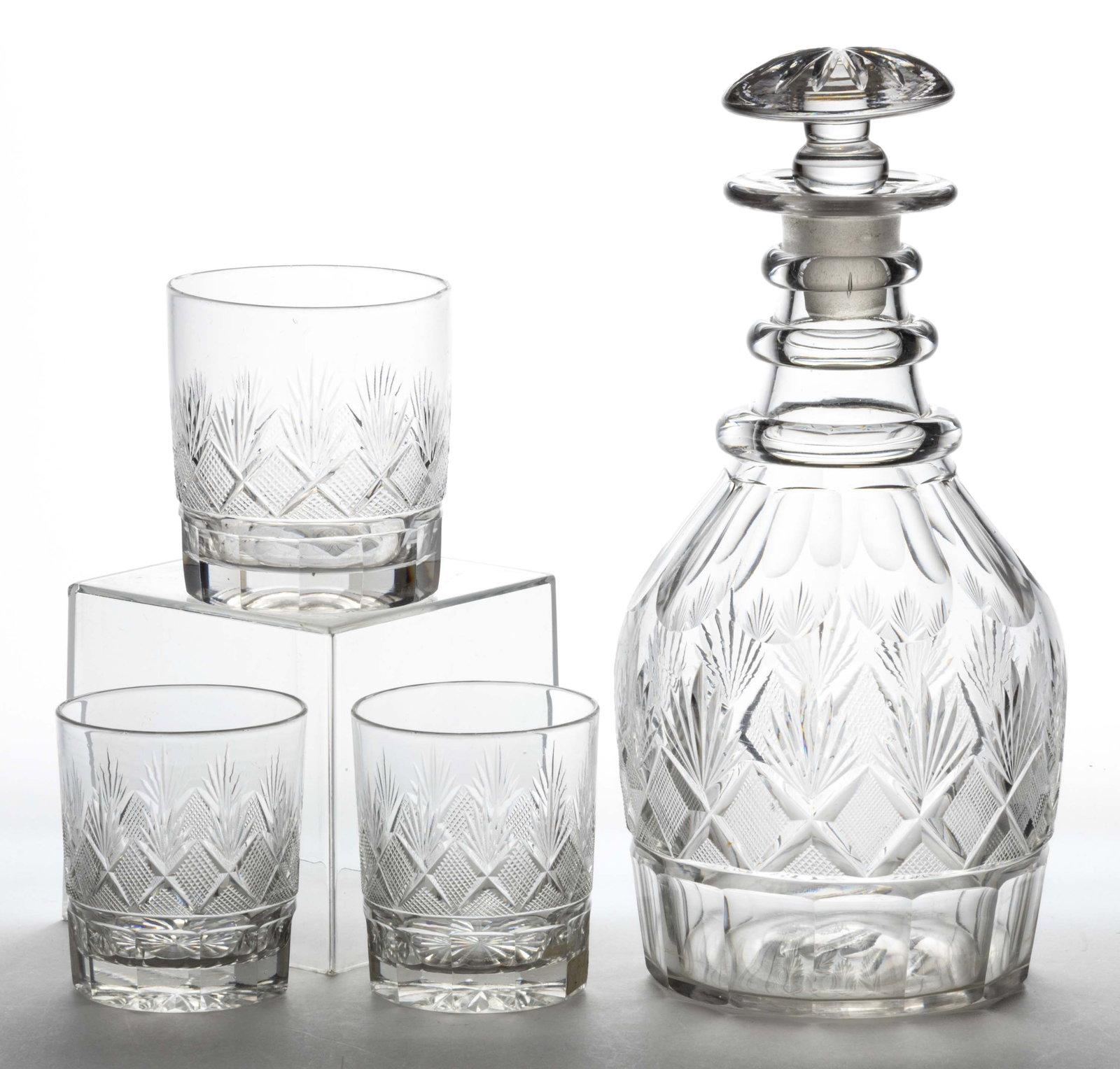 CUT STRAWBERRY DIAMONDS AND FANS DRINKING ARTICLES, LOT OF FOUR: CUT STRAWBERRY DIAMONDS AND FANS DRINKING ARTICLES, LOT OF FOUR, comprising a fluted-shoulder and panelled-base Prussian-form decanter with three applied neck rings and ray-cut mushroom stopper, a ful